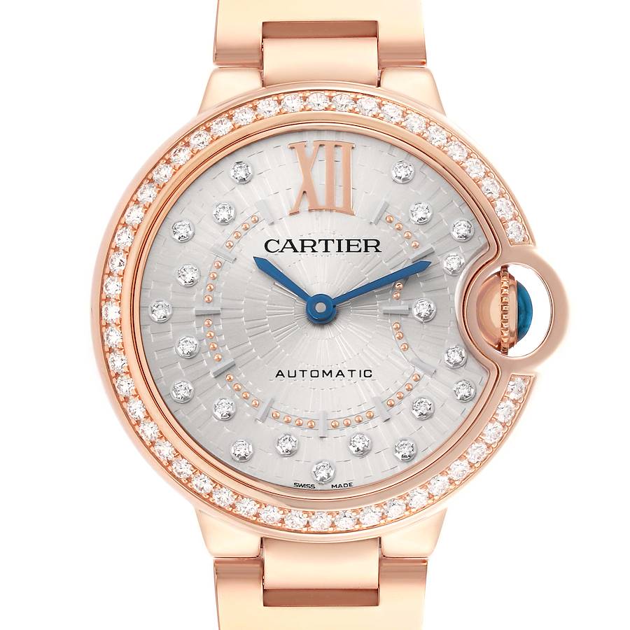 The Cartier Ballon Bleu watch is shown from the front, highlighting its diamond-set bezel, blue hands, and Roman numeral hour markers.