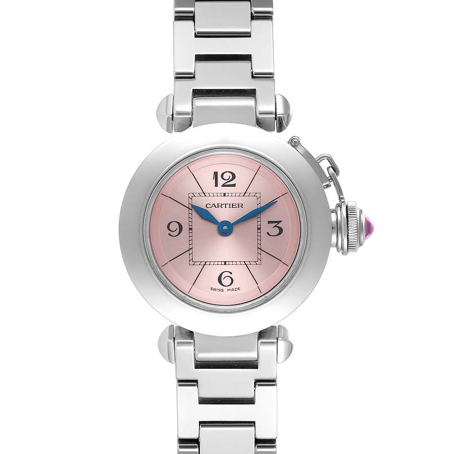 The Cartier Pasha watch is shown from a front angle, displaying its round face, pink dial, blue hands, and metal bracelet.