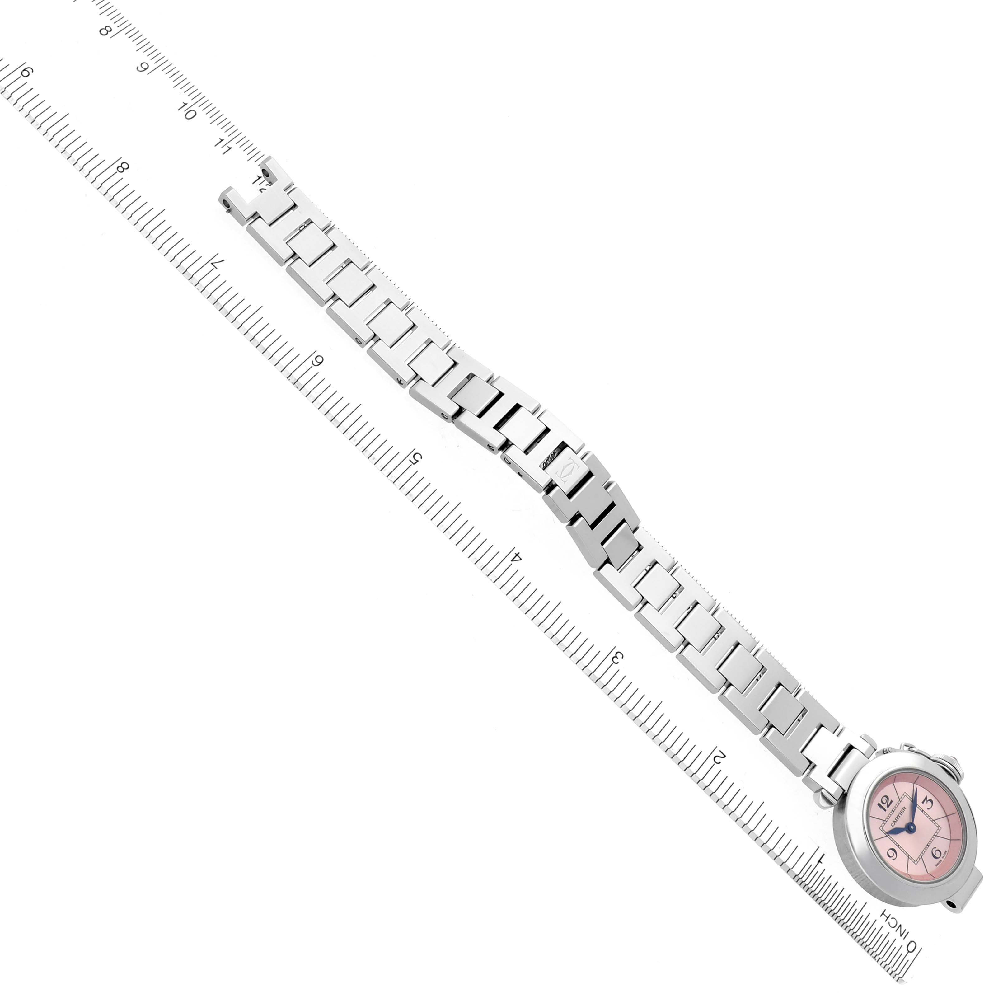 The Cartier Pasha W3140008 Women's Stainless Steel Pink Dial W3140008 Women's Stainless Steel Pink Dial watch is shown from an overhead angle, displaying the full bracelet with a pink dial placed against a ruler.