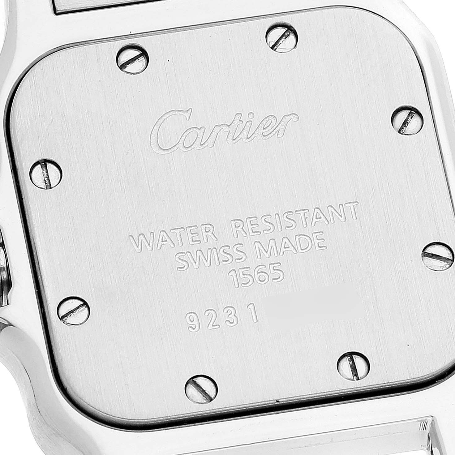 This image shows the back case of the Santos model by Cartier, displaying engravings, screws, and part of the bracelet attachment.