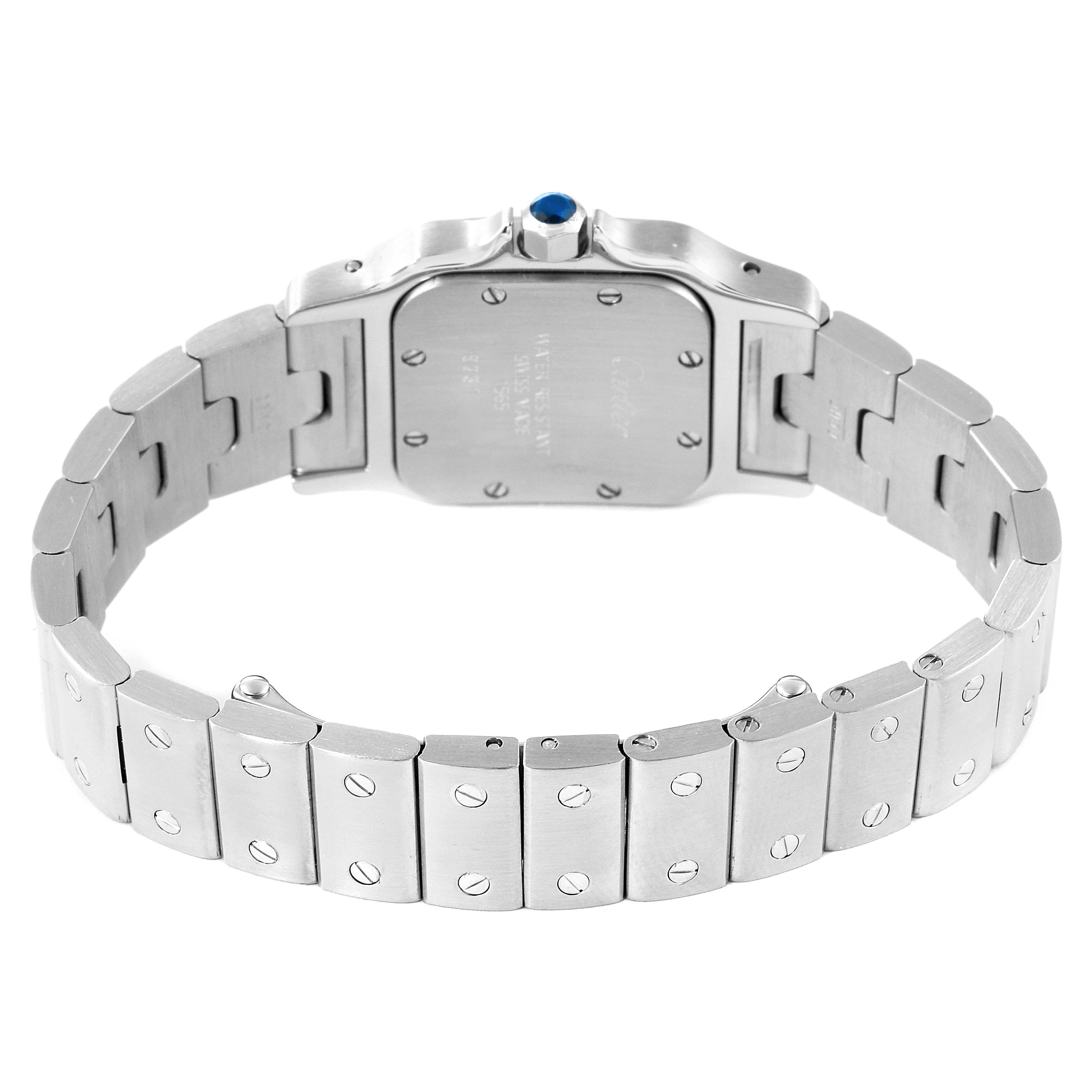 The image shows the back view and bracelet of a Santos model by Cartier, highlighting the case back screws and bracelet links.