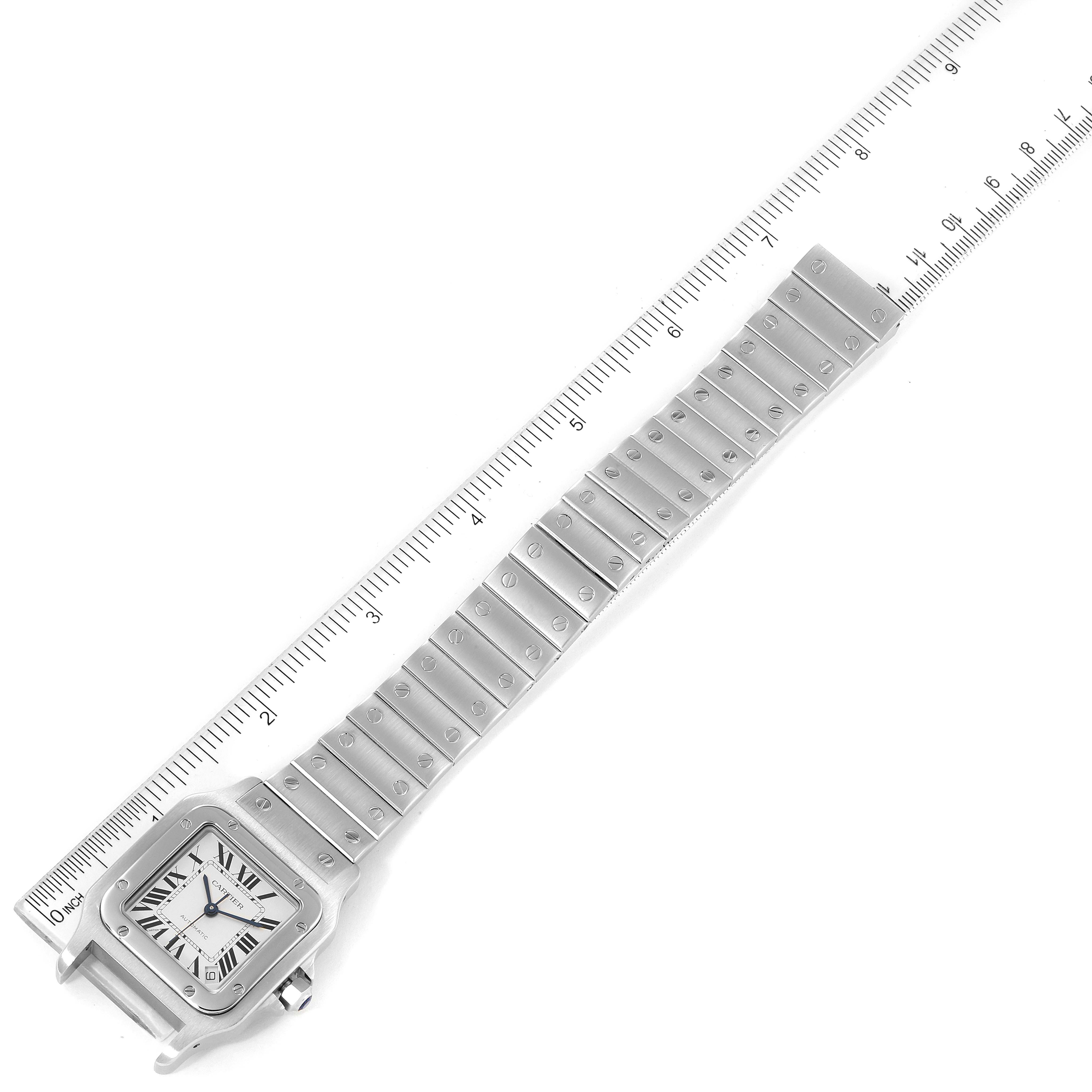 The image shows the Cartier Santos W20098D6 Men
s Stainless Steel Silver Dial W20098D6 Men
s Stainless Steel Silver Dial watch laid flat with a ruler to measure its length, highlighting the face and full bracelet.