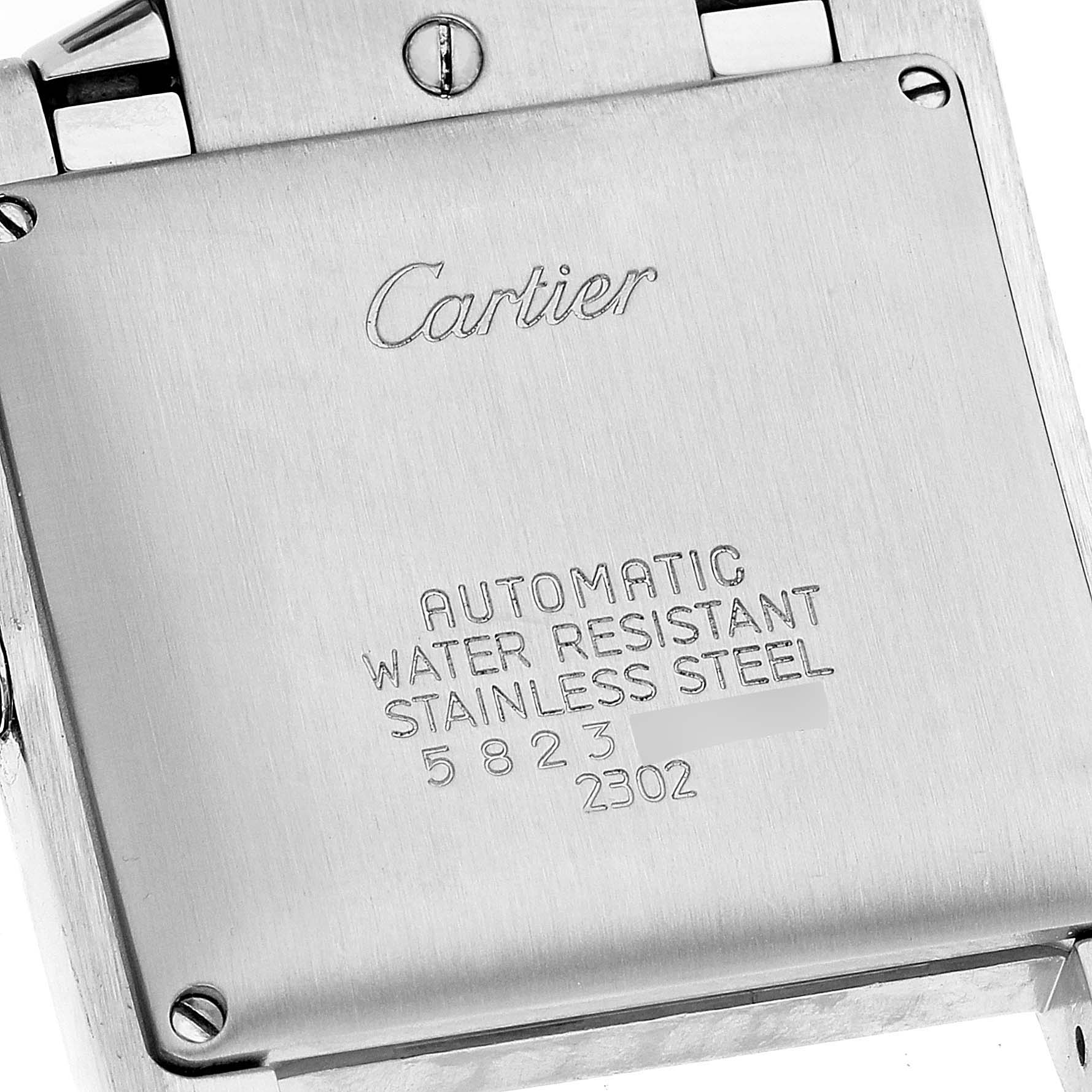 This image shows the stainless steel back of a Cartier Tank Francaise W51005Q4 Men's Steel and Gold (two tone) Silver Dial W51005Q4 Men's Steel and Gold (two tone) Silver Dial watch, highlighting its inscriptions and screws.