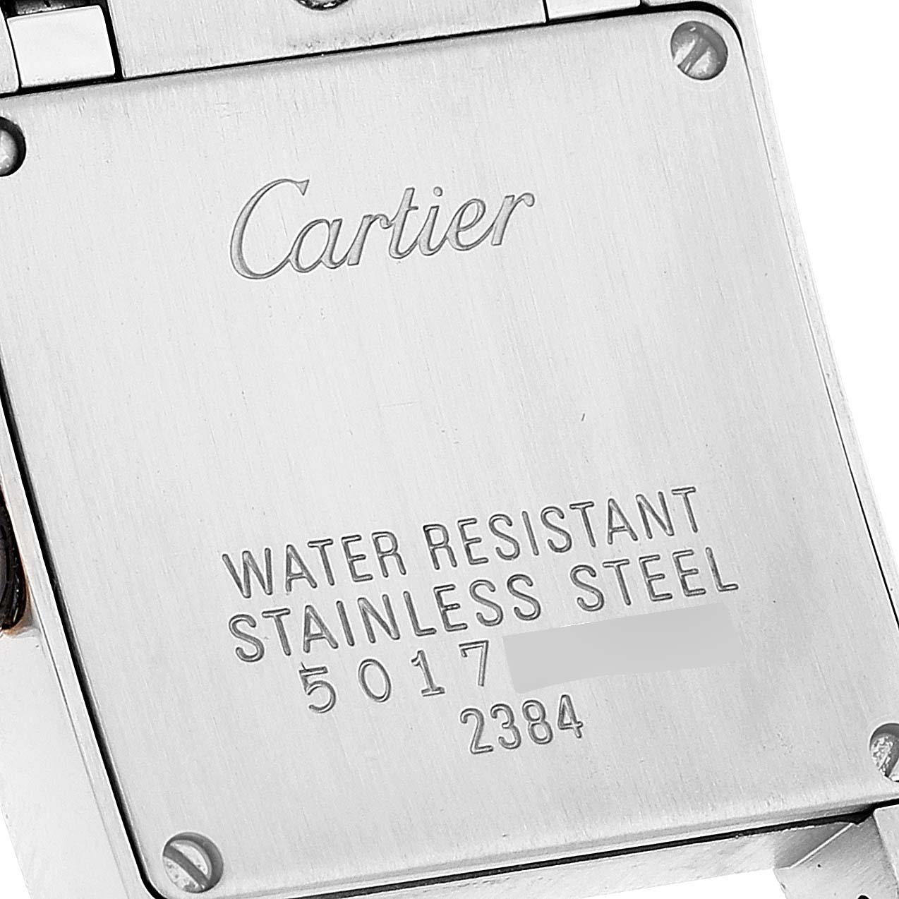 This is a close-up view of the back case of the Tank Française model by Cartier, showing the brand, water resistance, and material details.