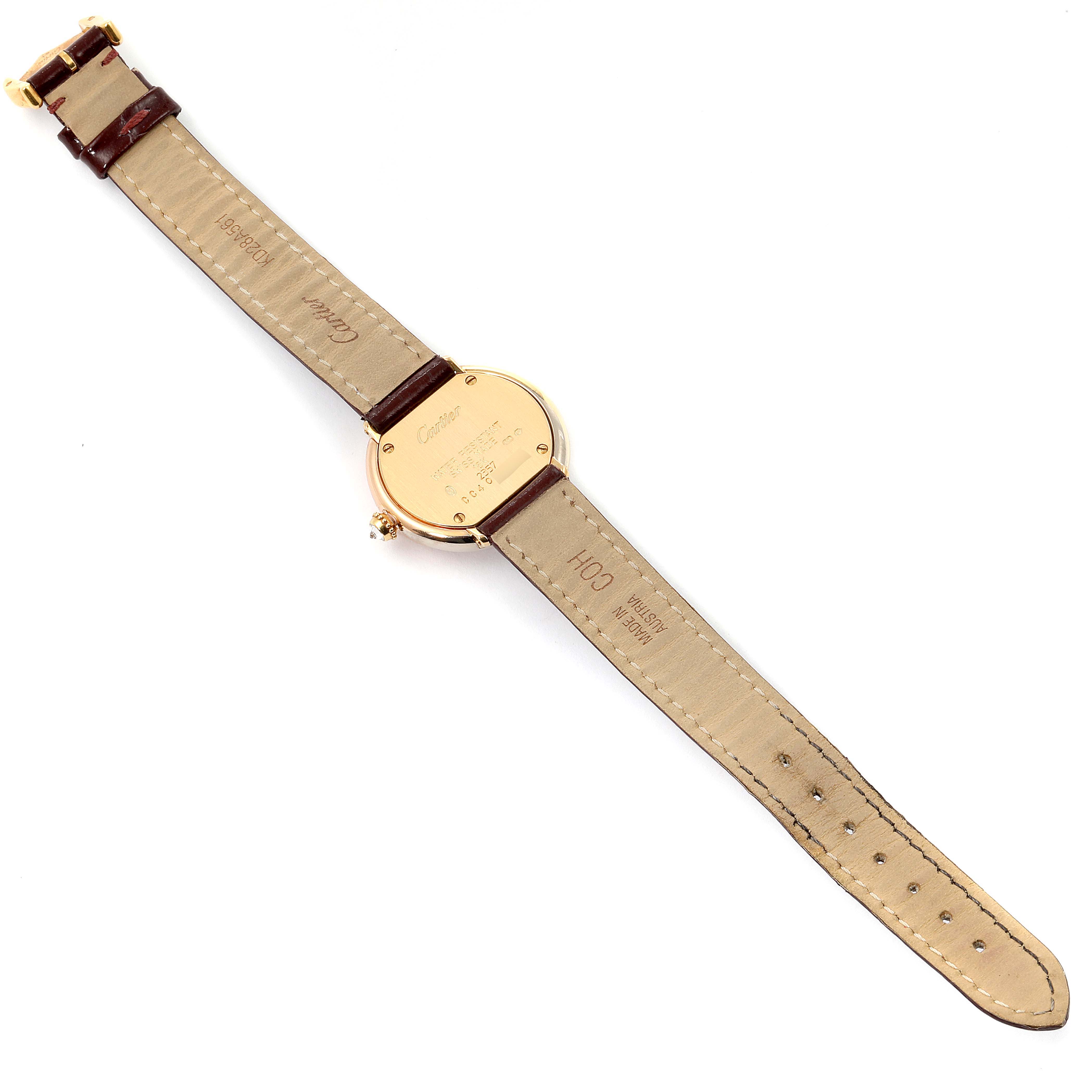 This image shows the back view of a Trinity model watch by Cartier, displaying the case back and leather strap.