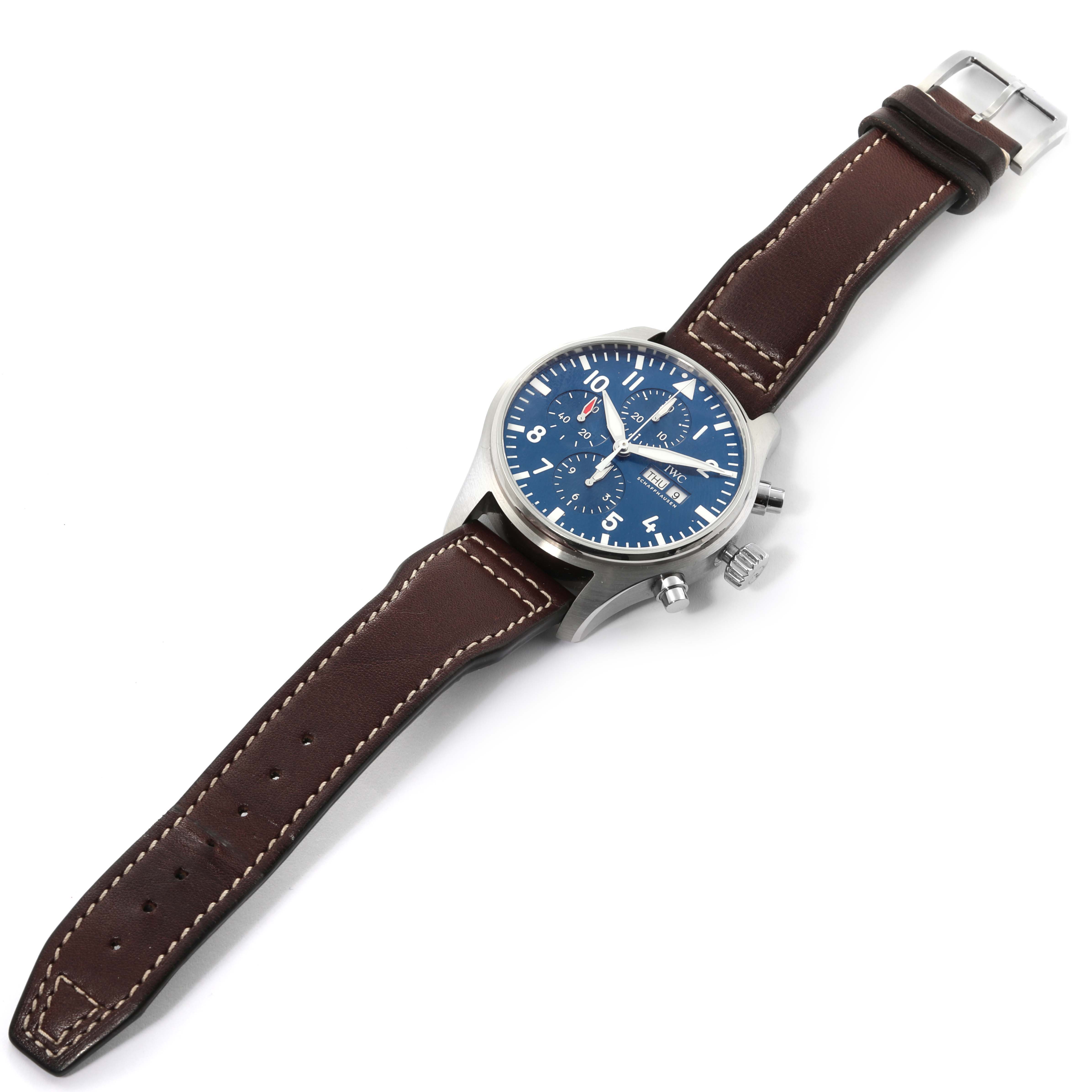 The image shows an IWC Pilot IW377714 Men's Stainless Steel Blue Dial IW377714 Men's Stainless Steel Blue Dial watch with a blue dial, chronograph functions, and a brown leather strap viewed from above.