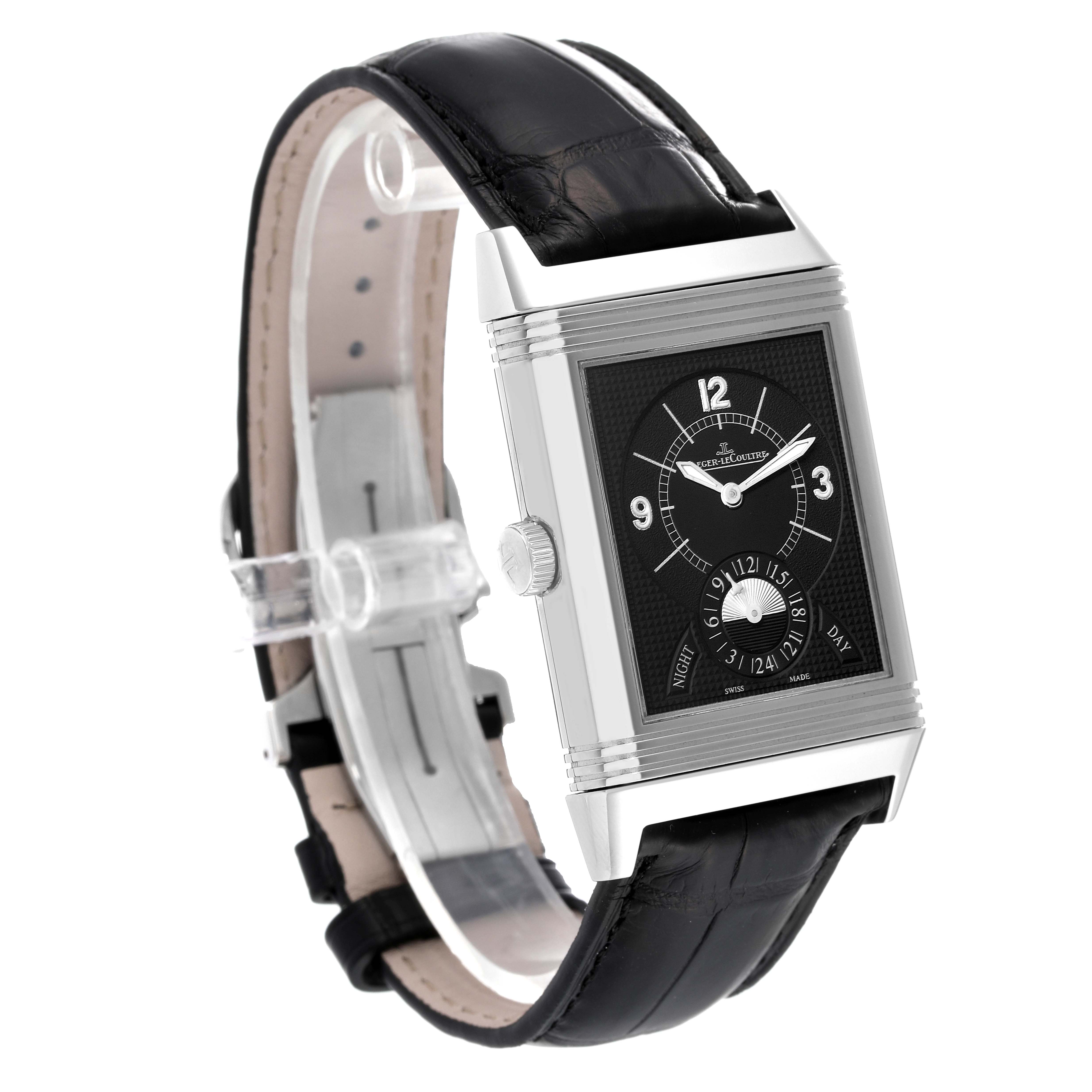 The Jaeger-LeCoultre Reverso watch is shown at a slight angle, highlighting the rectangular face, dial, and black leather strap.