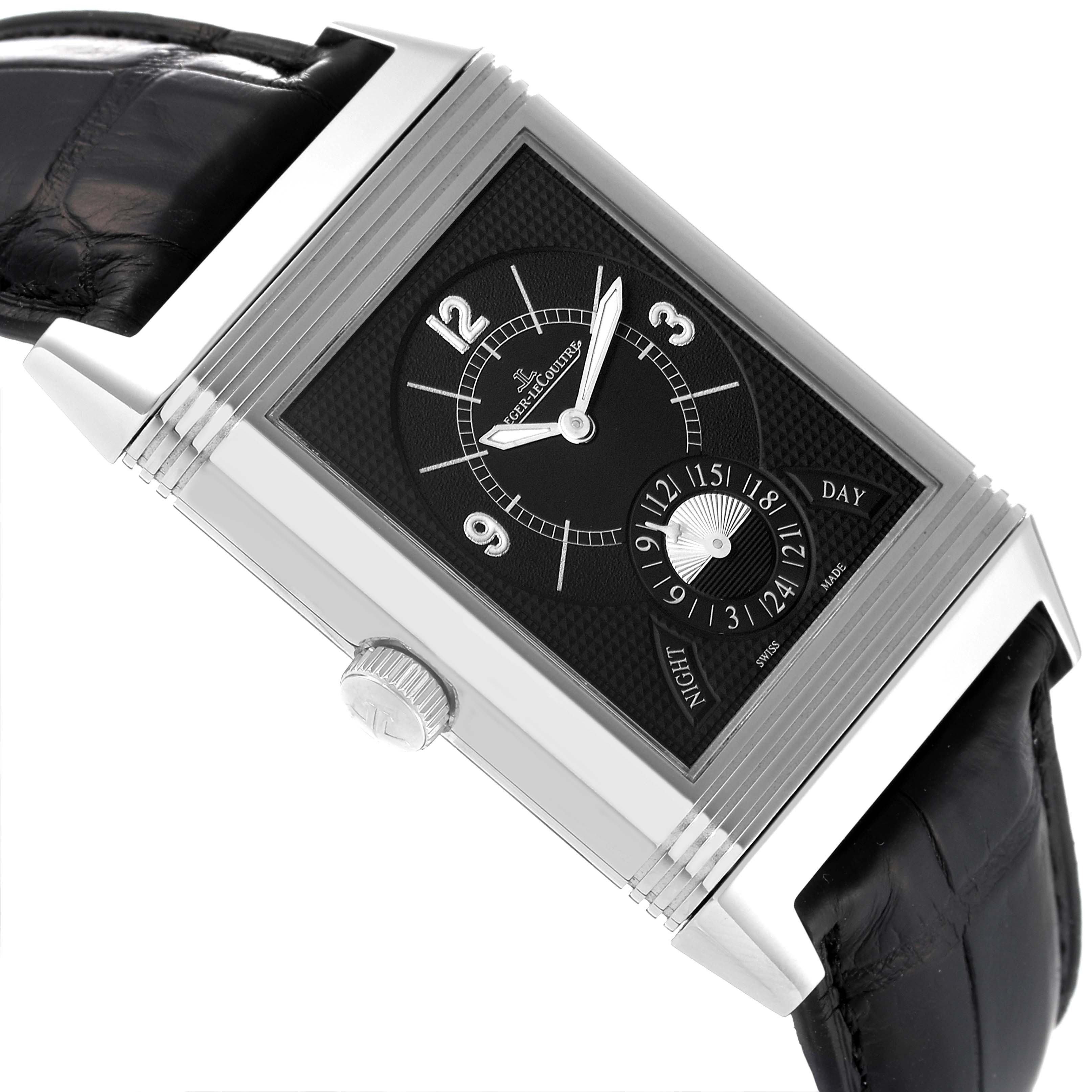 The image shows a close-up of the dial side of a Jaeger-LeCoultre Reverso watch, highlighting its crown, black strap, and face details.
