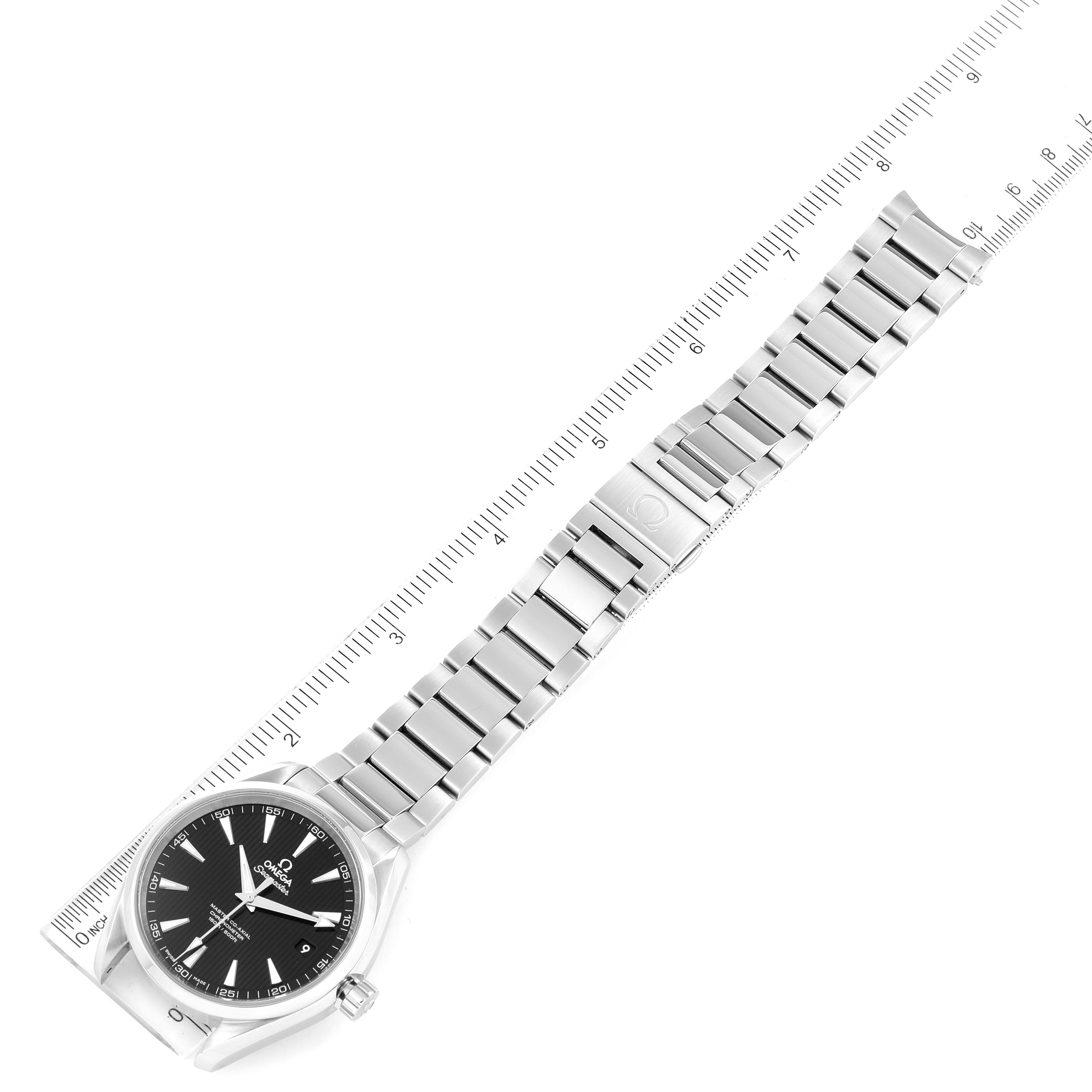 This image shows an Omega Aqua Terra 231.10.42.21.01.003 Men's Stainless Steel Black Dial 231.10.42.21.01.003 Men's Stainless Steel Black Dial watch with a black dial and stainless steel bracelet laid out alongside a ruler.