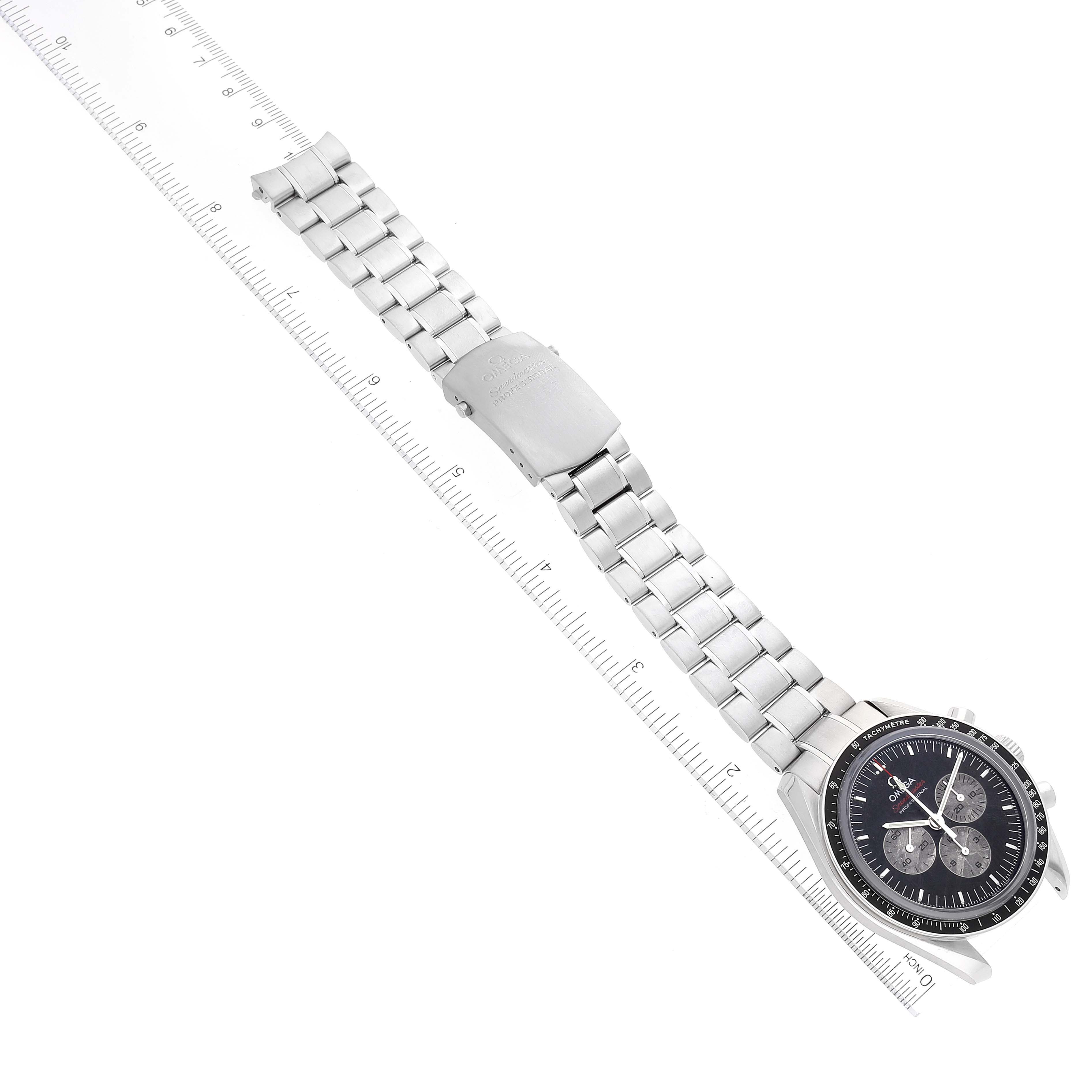 This image shows the Omega Speedmaster 311.30.42.30.99.001 Men's Stainless Steel Silver Dial 311.30.42.30.99.001 Men's Stainless Steel Silver Dial watch from an angle displaying the face, metal bracelet, and clasp, along with a ruled measure for scale.