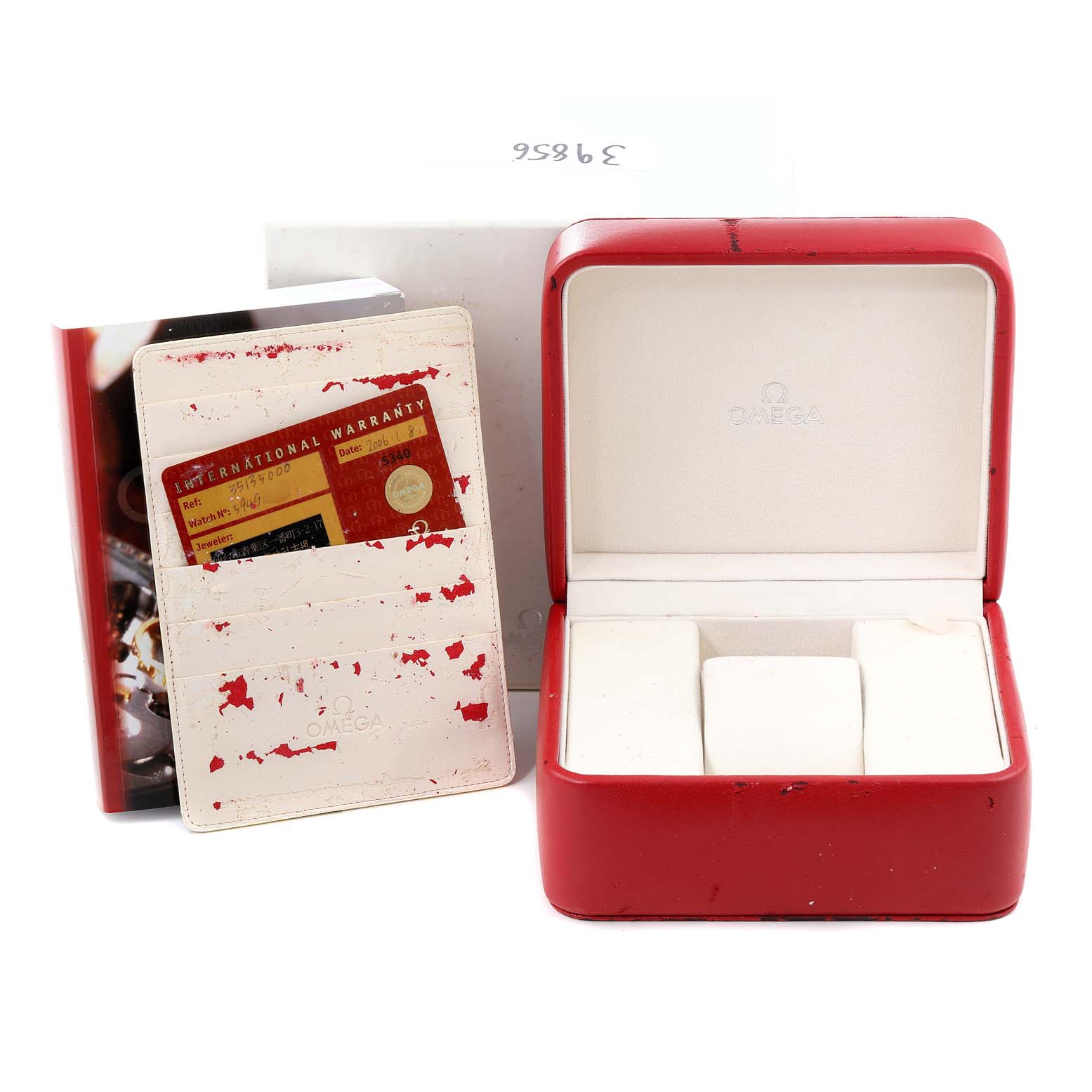 The image shows an Omega Speedmaster 3513.50.00 Men
s Stainless Steel Black Dial 3513.50.00 Men
s Stainless Steel Black Dial watch box and warranty card holder with its original packaging.