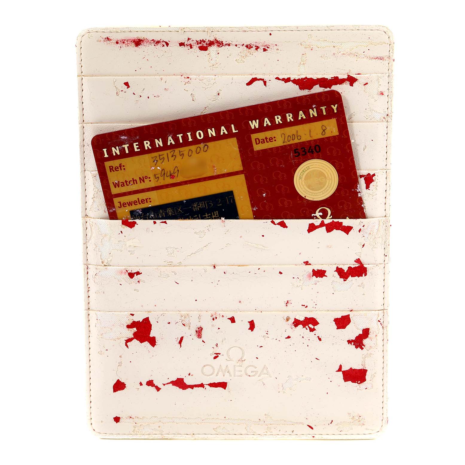 The image shows an International Warranty card in a holder for an Omega Speedmaster 3513.50.00 Men
s Stainless Steel Black Dial 3513.50.00 Men
s Stainless Steel Black Dial watch.