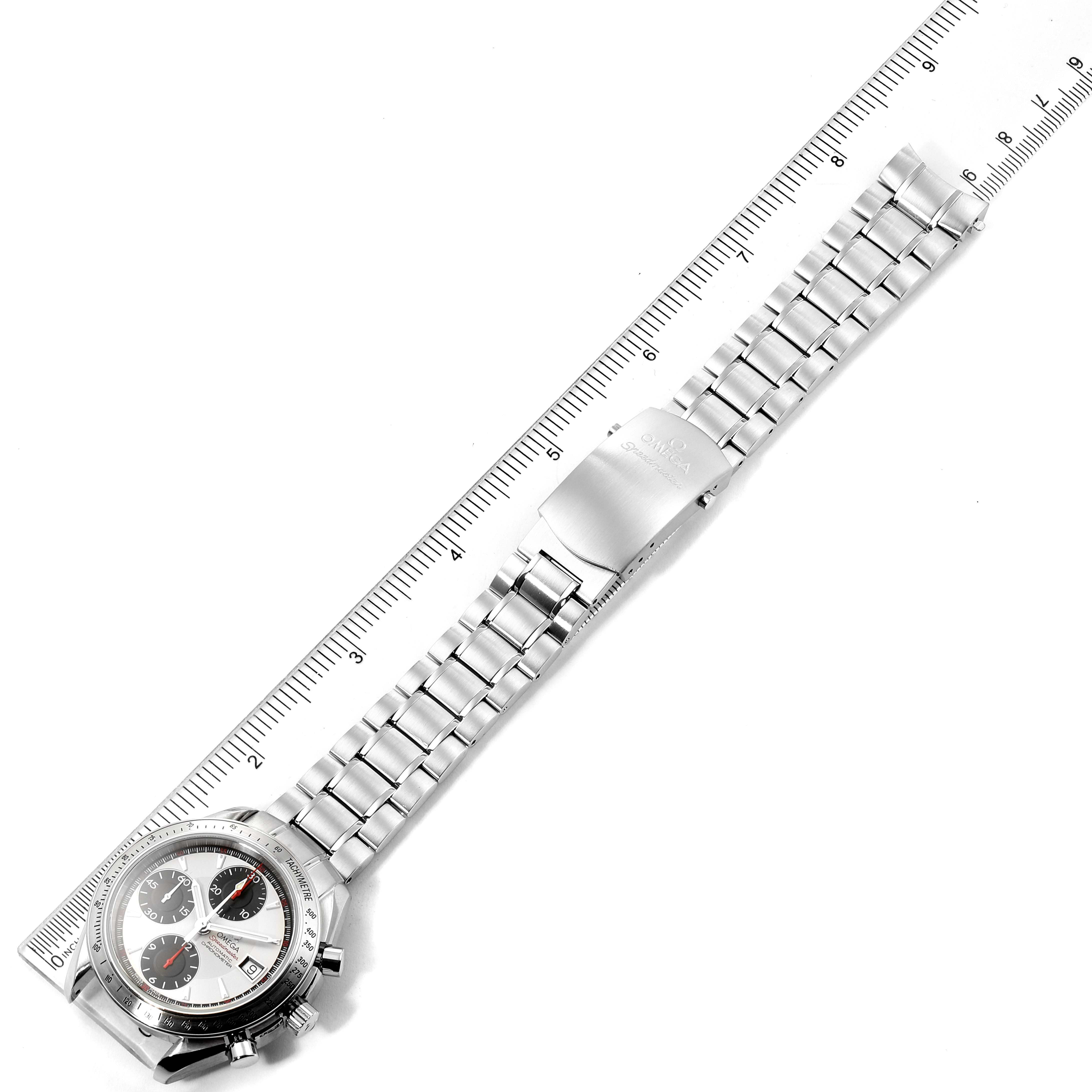 The Omega Speedmaster 3211.31.00 Men
s Stainless Steel Silver Dial 3211.31.00 Men
s Stainless Steel Silver Dial watch is shown from a top-down angle, displaying its bracelet and clasp against a ruler for scale.