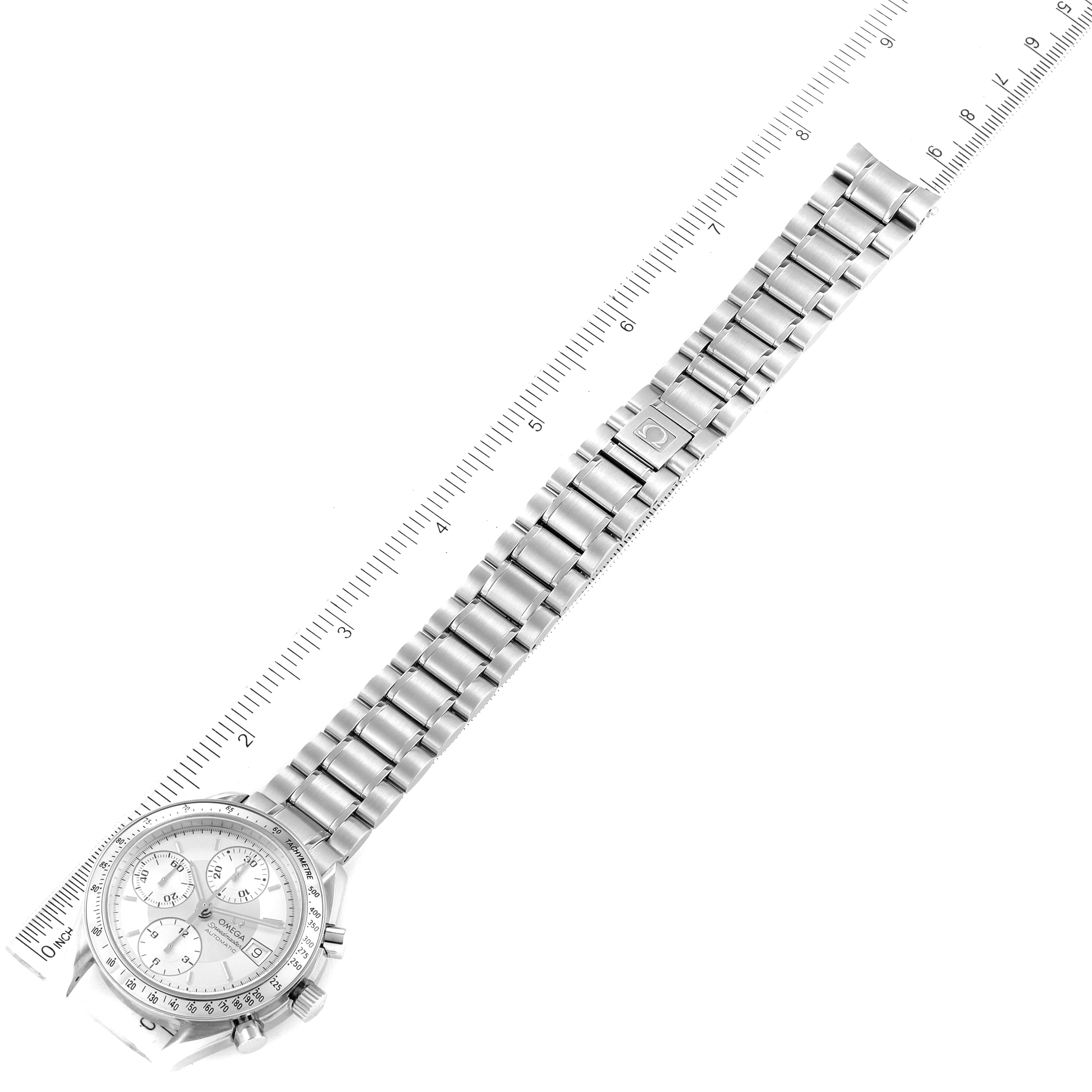This image shows a top-down view of an Omega Speedmaster 3513.30.00 Men
s Stainless Steel Silver Dial 3513.30.00 Men
s Stainless Steel Silver Dial watch and its stainless steel bracelet laid alongside a ruler.