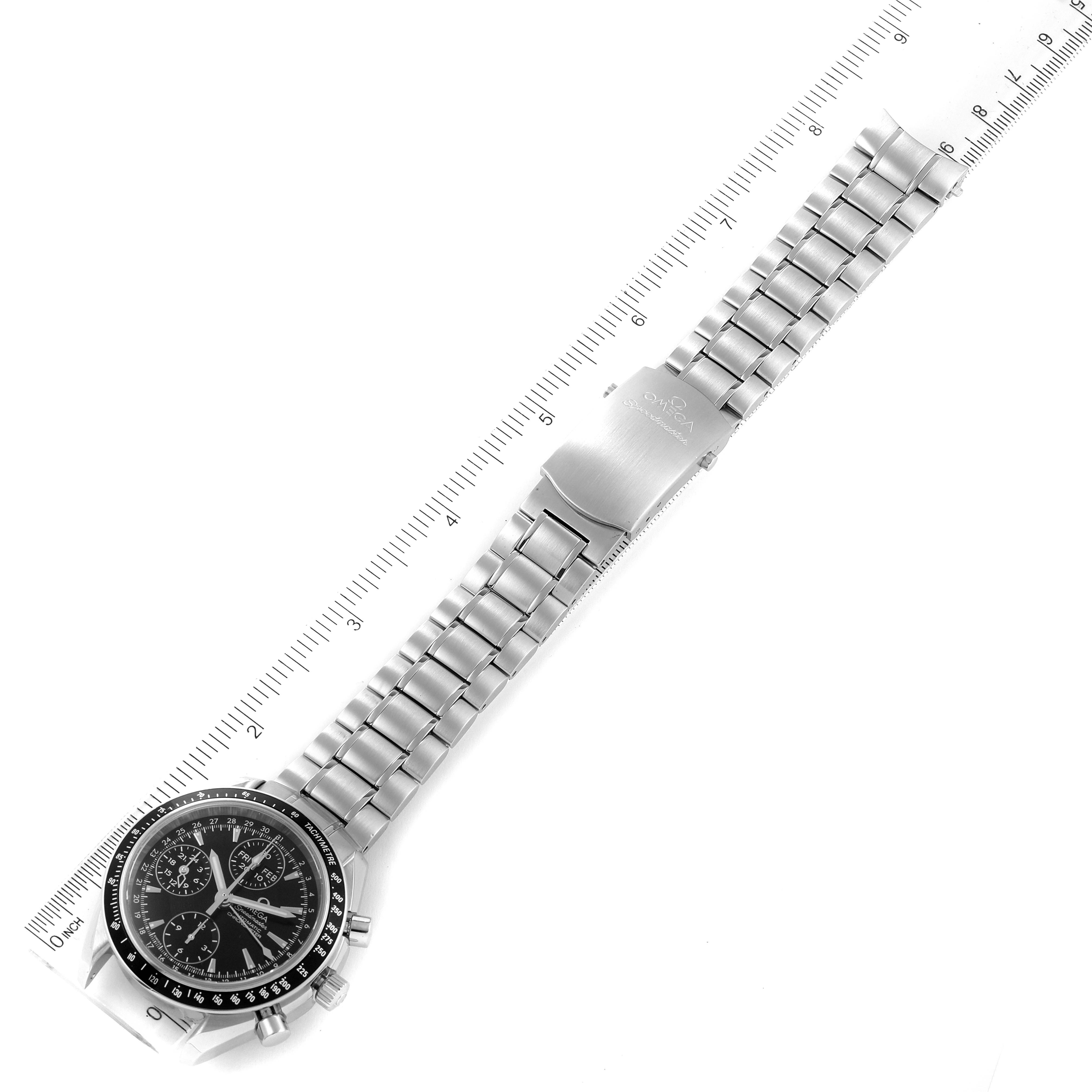 The image shows a top-down view of an Omega Speedmaster 3220.50.00 Men
s Stainless Steel Black Dial 3220.50.00 Men
s Stainless Steel Black Dial watch, emphasizing the dial, bracelet, and clasp alongside a ruler for scale.