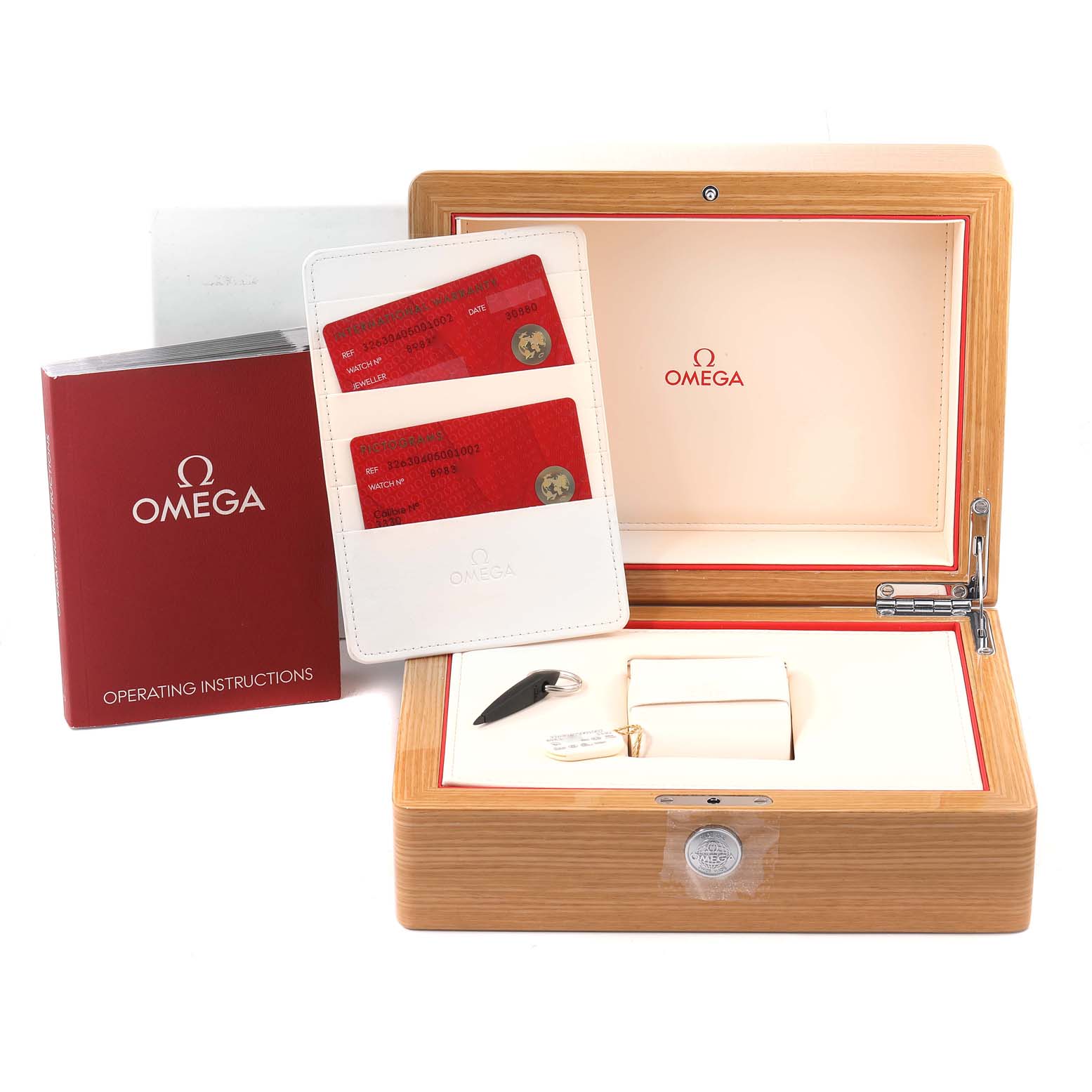 The image shows the Omega Speedmaster 326.30.40.50.01.002 Men's Stainless Steel Black Dial 326.30.40.50.01.002 Men's Stainless Steel Black Dial watch box, warranty cards, operating instructions booklet, a case, and a tool.