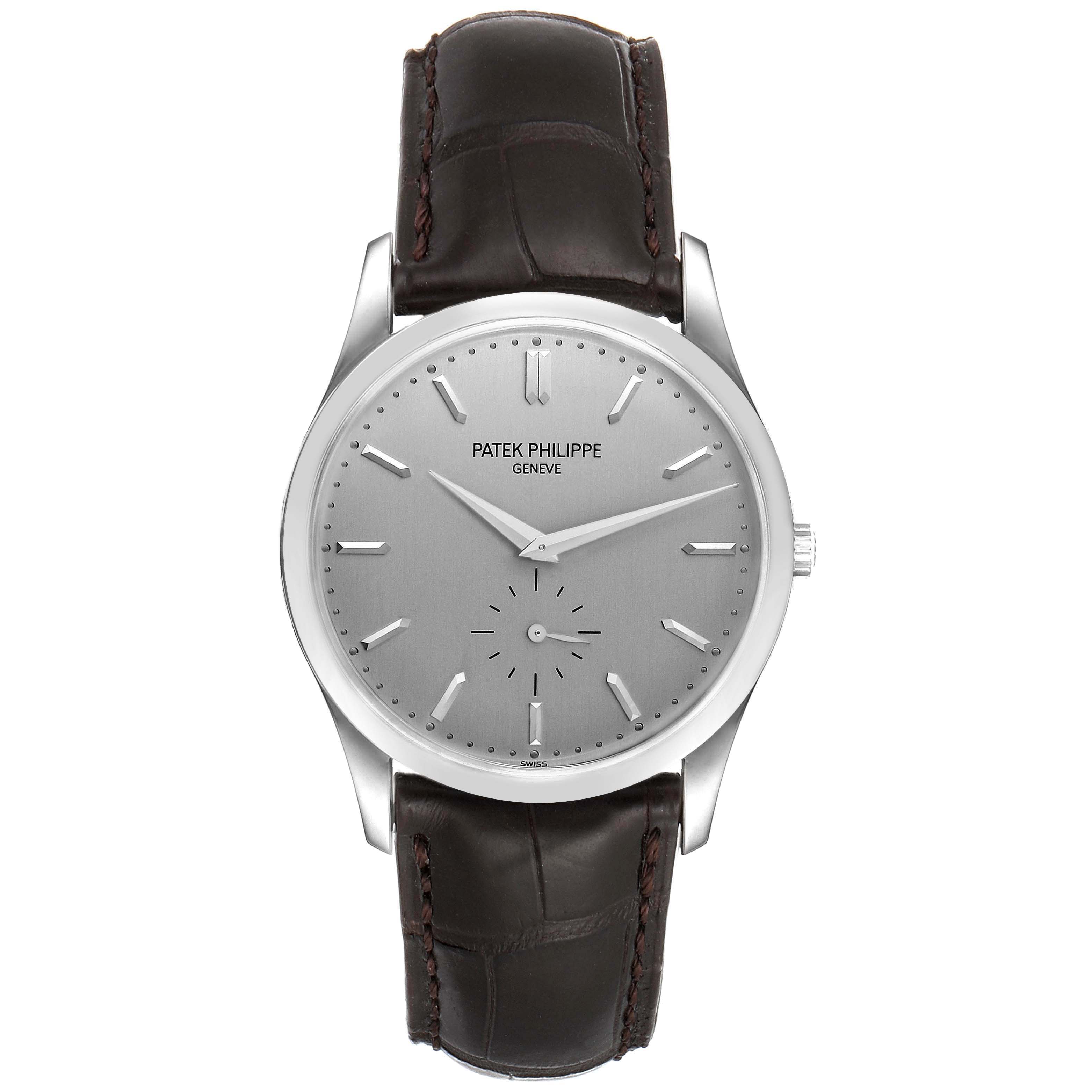 The image shows a front view of a Patek Philippe Calatrava 5196G Men's White Gold Silver Dial 5196G Men's White Gold Silver Dial watch, highlighting the face, hands, markers, and leather strap.
