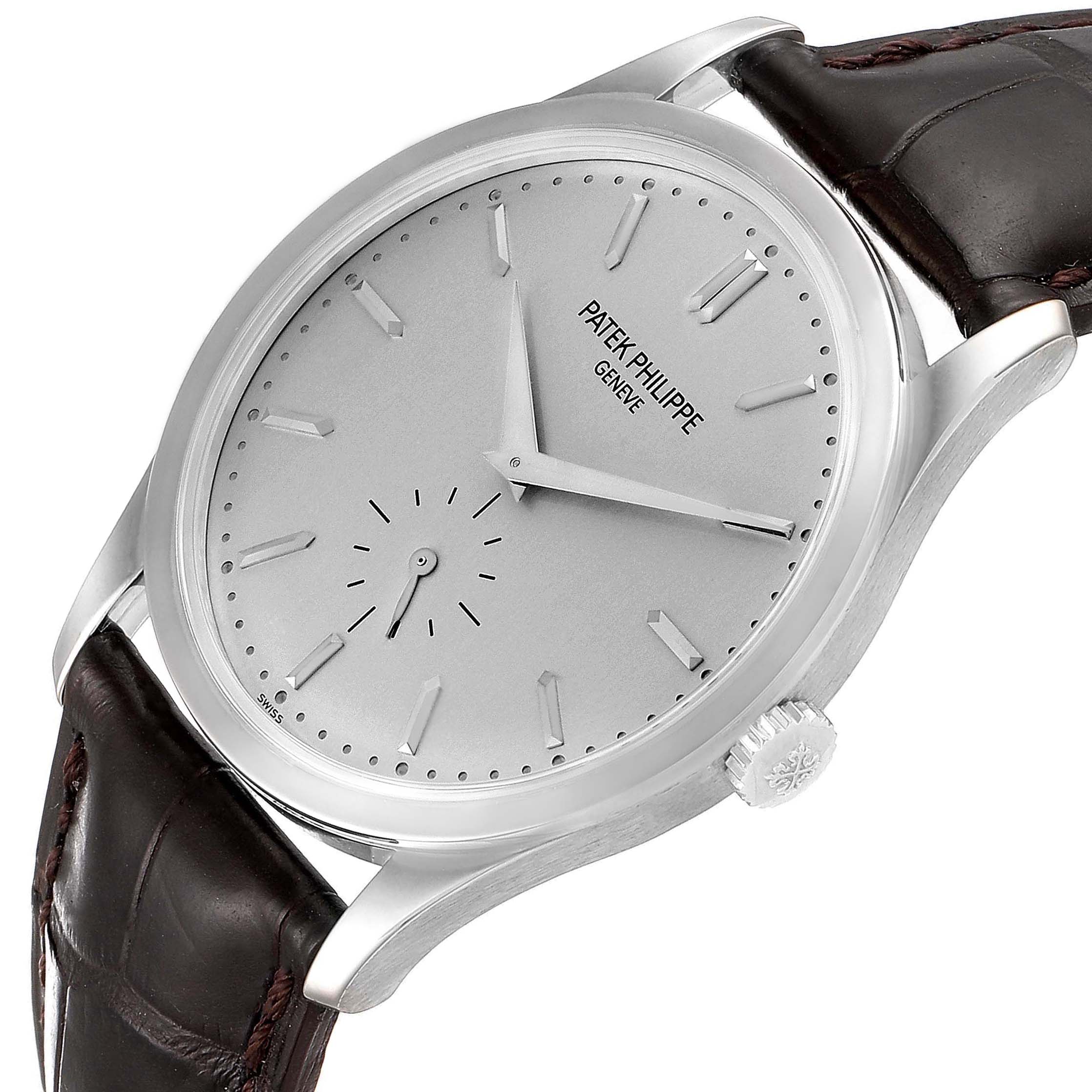 This image shows a Patek Philippe Calatrava 5196G Men's White Gold Silver Dial 5196G Men's White Gold Silver Dial watch at an angle displaying the dial, crown, case, and part of the leather strap.
