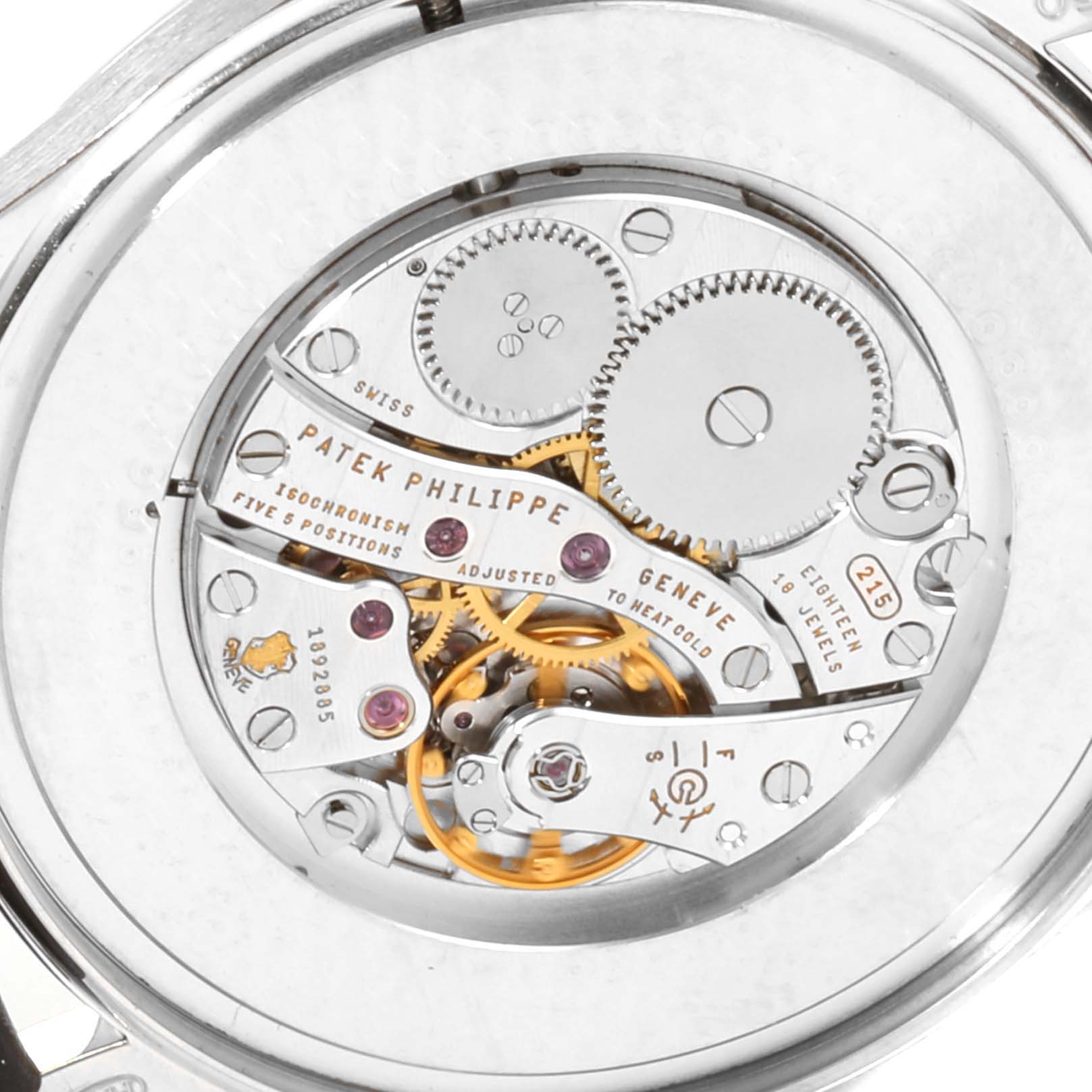 This image shows the intricate internal mechanism and engraved details of a Patek Philippe Calatrava 5196G Men's White Gold Silver Dial 5196G Men's White Gold Silver Dial watch from a close-up angle.