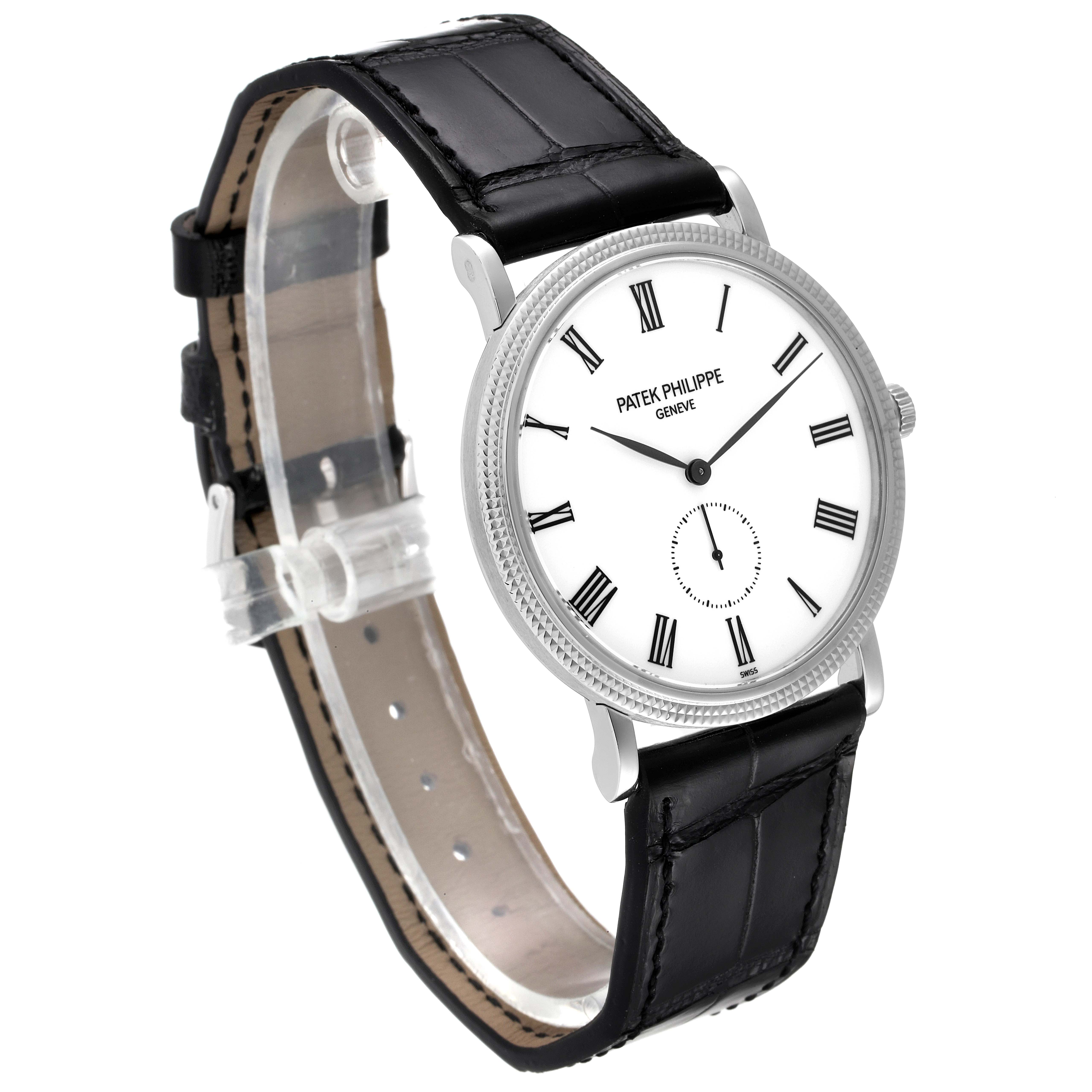 The image shows a Patek Philippe Calatrava 5119G Men
s White Gold White Dial 5119G Men
s White Gold White Dial watch at a slight angle, with a leather strap and its face displaying Roman numerals.