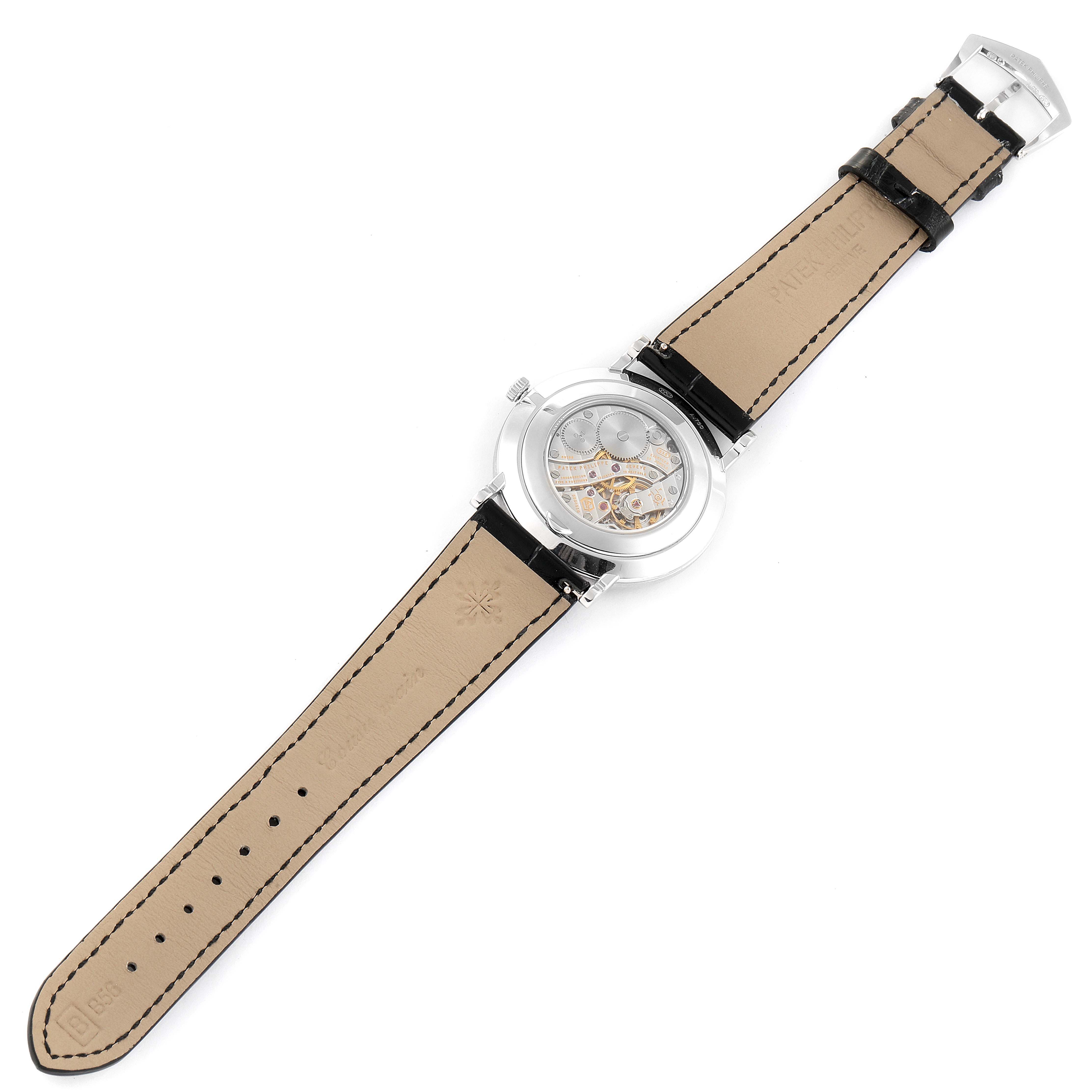 The image shows the back view of a Patek Philippe Calatrava 5119G Men
s White Gold White Dial 5119G Men
s White Gold White Dial watch, highlighting the leather strap, buckle, and visible inner mechanism.