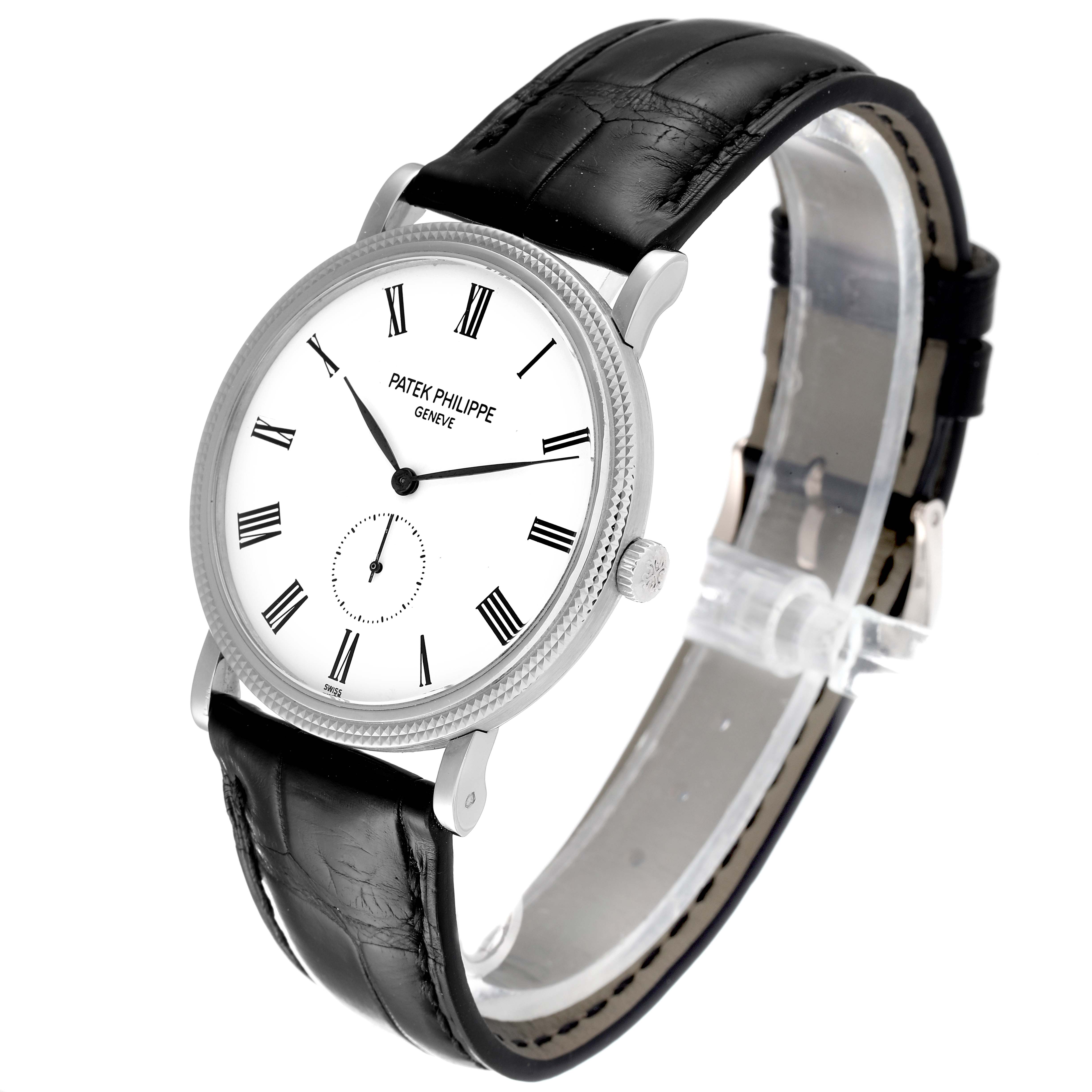 The image shows a Patek Philippe Calatrava 5119G Men
s White Gold White Dial 5119G Men
s White Gold White Dial watch from a slightly angled side view, highlighting the face, bezel, crown, and leather strap.