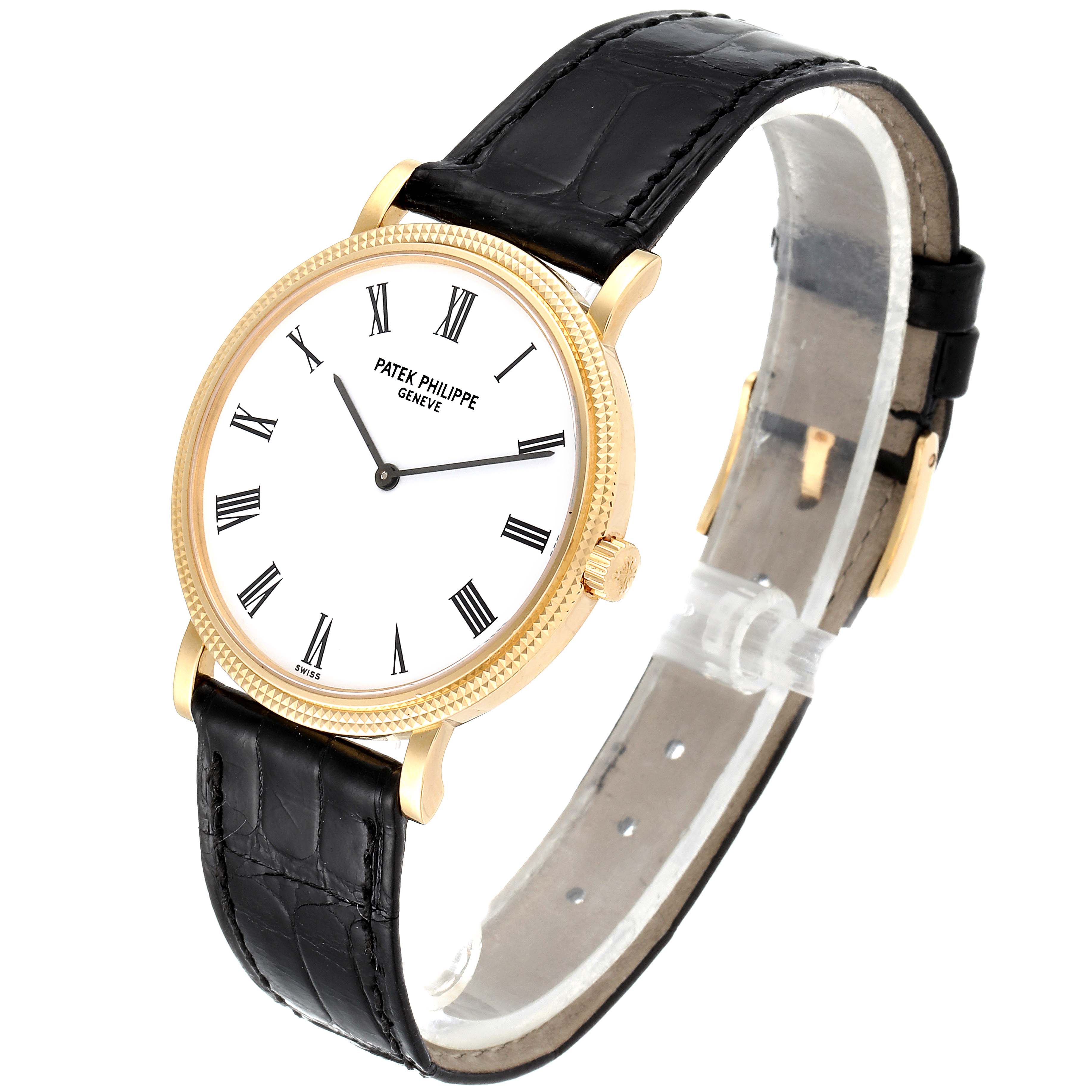 This image shows a Patek Philippe Calatrava 5120J Men's Yellow Gold White Dial 5120J Men's Yellow Gold White Dial watch from an oblique angle, highlighting its face, bezel, crown, and leather strap.