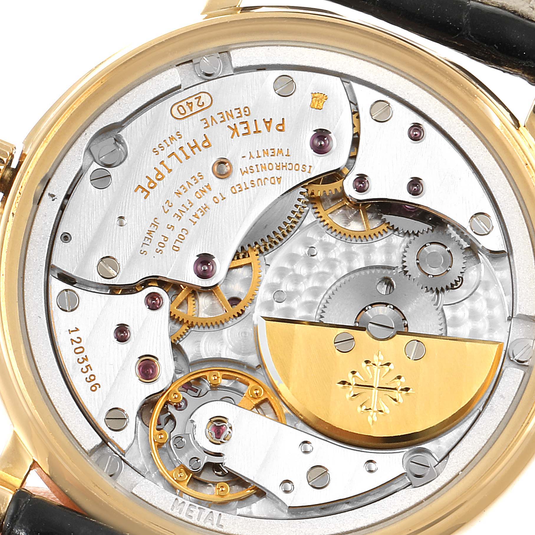 The image shows the back view of a Patek Philippe Calatrava 5120J Men's Yellow Gold White Dial 5120J Men's Yellow Gold White Dial watch, displaying its intricate mechanical movement and components.