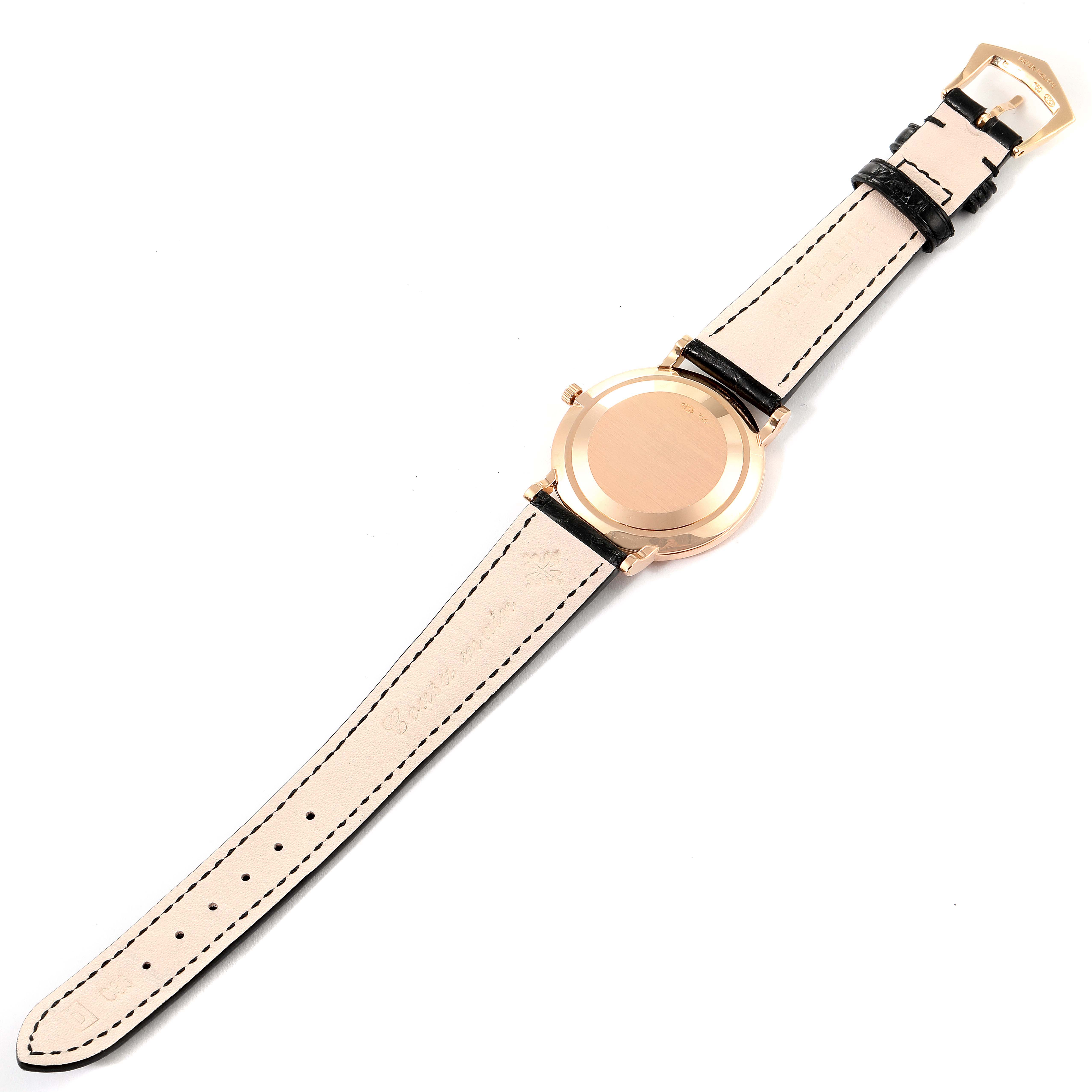 The image shows a Calatrava watch by Patek Philippe from the back, highlighting the case back and leather strap.