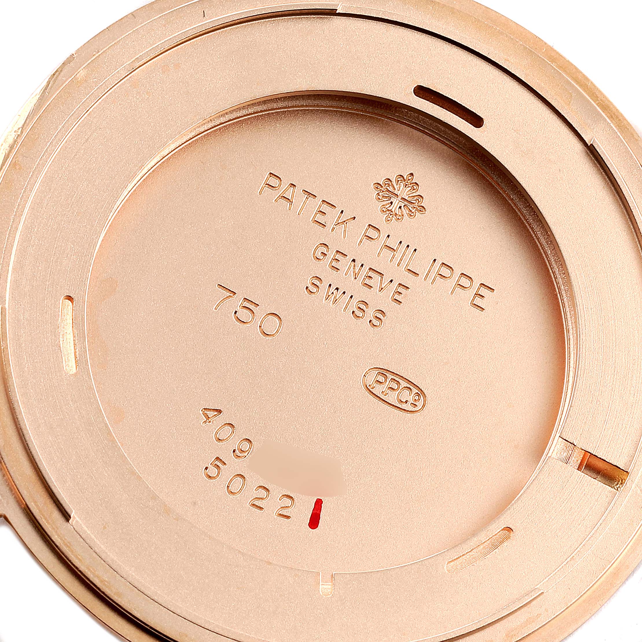 This image shows the case back of a Patek Philippe Calatrava 5022R Men
s Rose Gold White Dial 5022R Men
s Rose Gold White Dial model watch from an angle revealing its engravings.