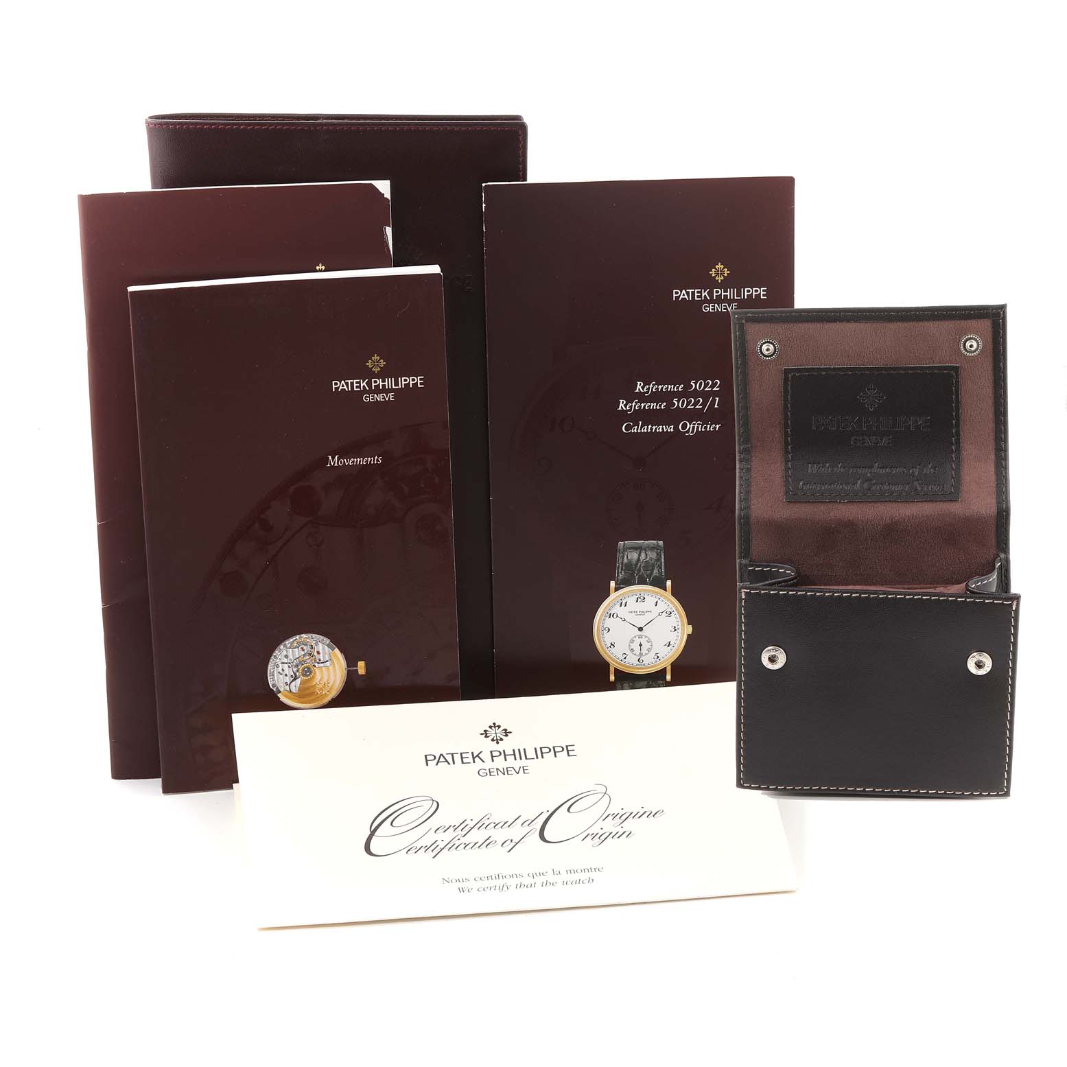 The image shows Patek Philippe Calatrava 5022R Men
s Rose Gold White Dial 5022R Men
s Rose Gold White Dial accessories including manuals, a certificate, and a watch case, all at a frontal angle.