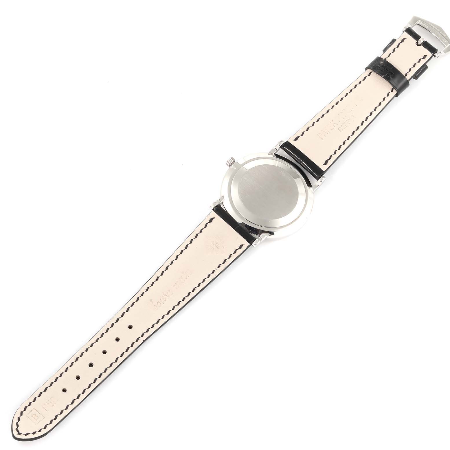 The image shows the back view of a Patek Philippe Calatrava 5022G Men's White Gold White Dial 5022G Men's White Gold White Dial watch, displaying its case back and leather strap.