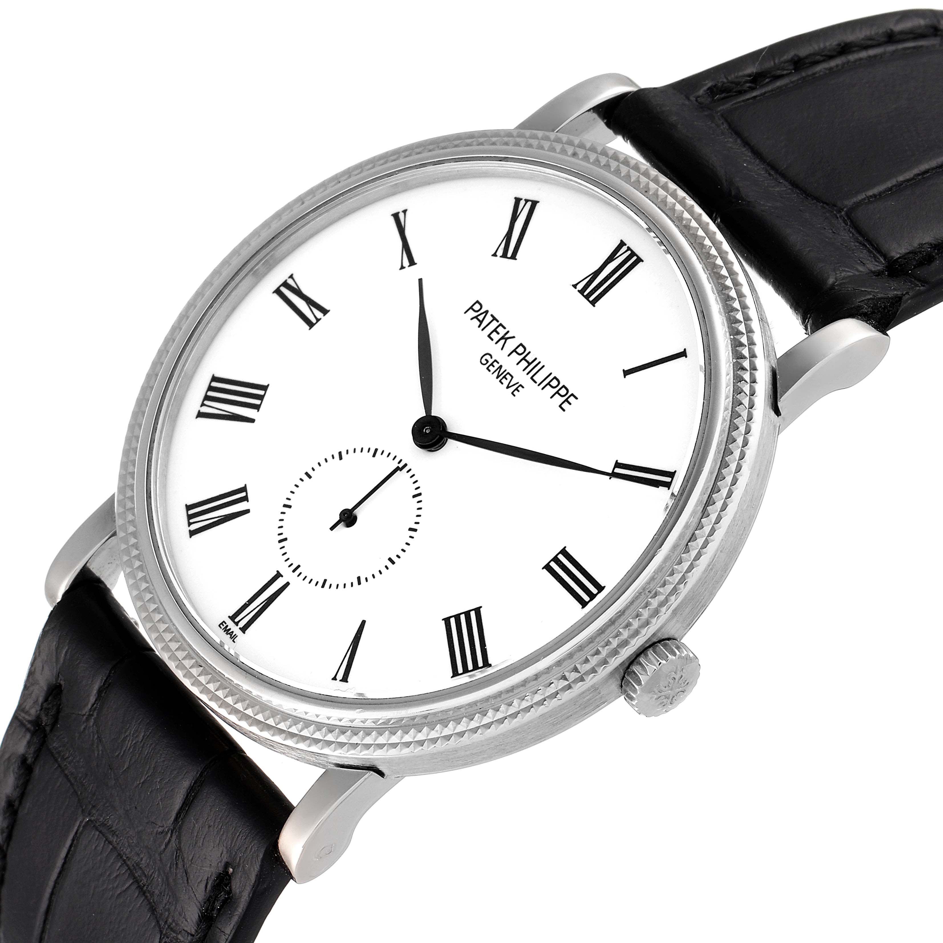 The image shows a Patek Philippe Calatrava 5116G Men
s White Gold White Dial 5116G Men
s White Gold White Dial watch at an angled view, highlighting its face, bezel, crown, and black strap.