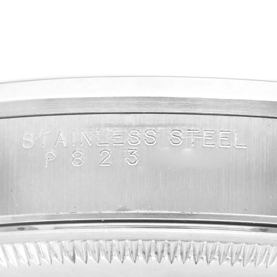 The image shows a close-up view of the stainless steel case edge of a Rolex Air-King 14000M Men's Stainless Steel Blue Dial 14000M Men's Stainless Steel Blue Dial watch, with engraved text visible.