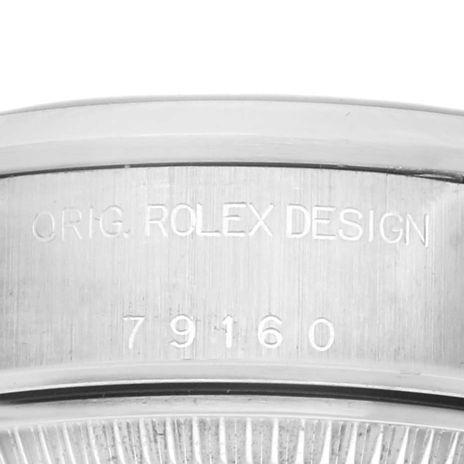 This image shows a close-up of the case side of a Rolex Date 79160 Women's Stainless Steel White Dial 79160 Women's Stainless Steel White Dial model, featuring its model number engraving.