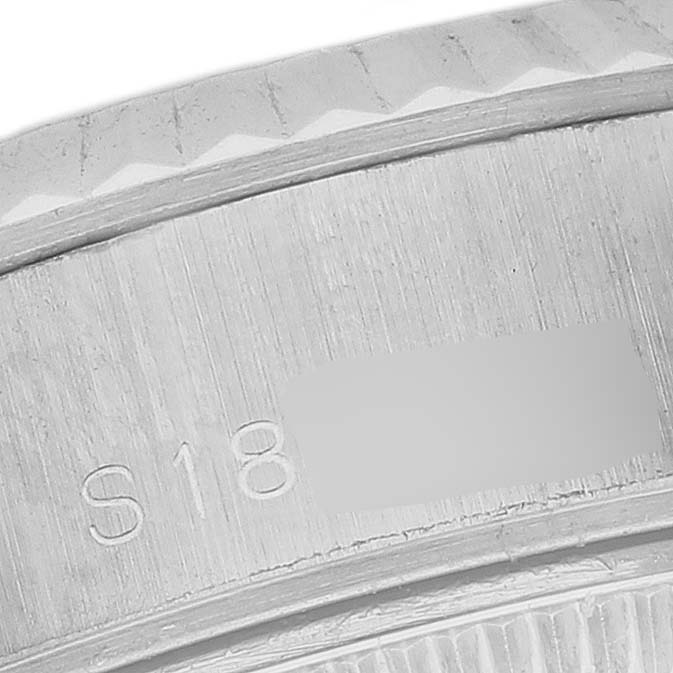 This close-up image shows a partial view of the fluted bezel and case edge of a Rolex Datejust 69174 Women's Stainless Steel White Dial 69174 Women's Stainless Steel White Dial watch.