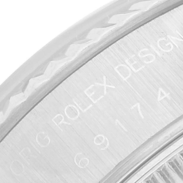 The image shows a close-up of the edge of the bezel and part of the casing of the Rolex Datejust 69174 Women's Stainless Steel Black Dial 69174 Women's Stainless Steel Black Dial.