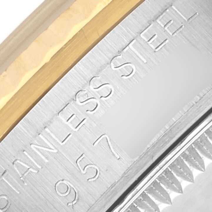 The image shows a close-up of the Rolex Mid-Size 68273 Women's Steel and Gold (two tone) White Dial 68273 Women's Steel and Gold (two tone) White Dial model's bezel, highlighting the "STAINLESS STEEL" engraving.