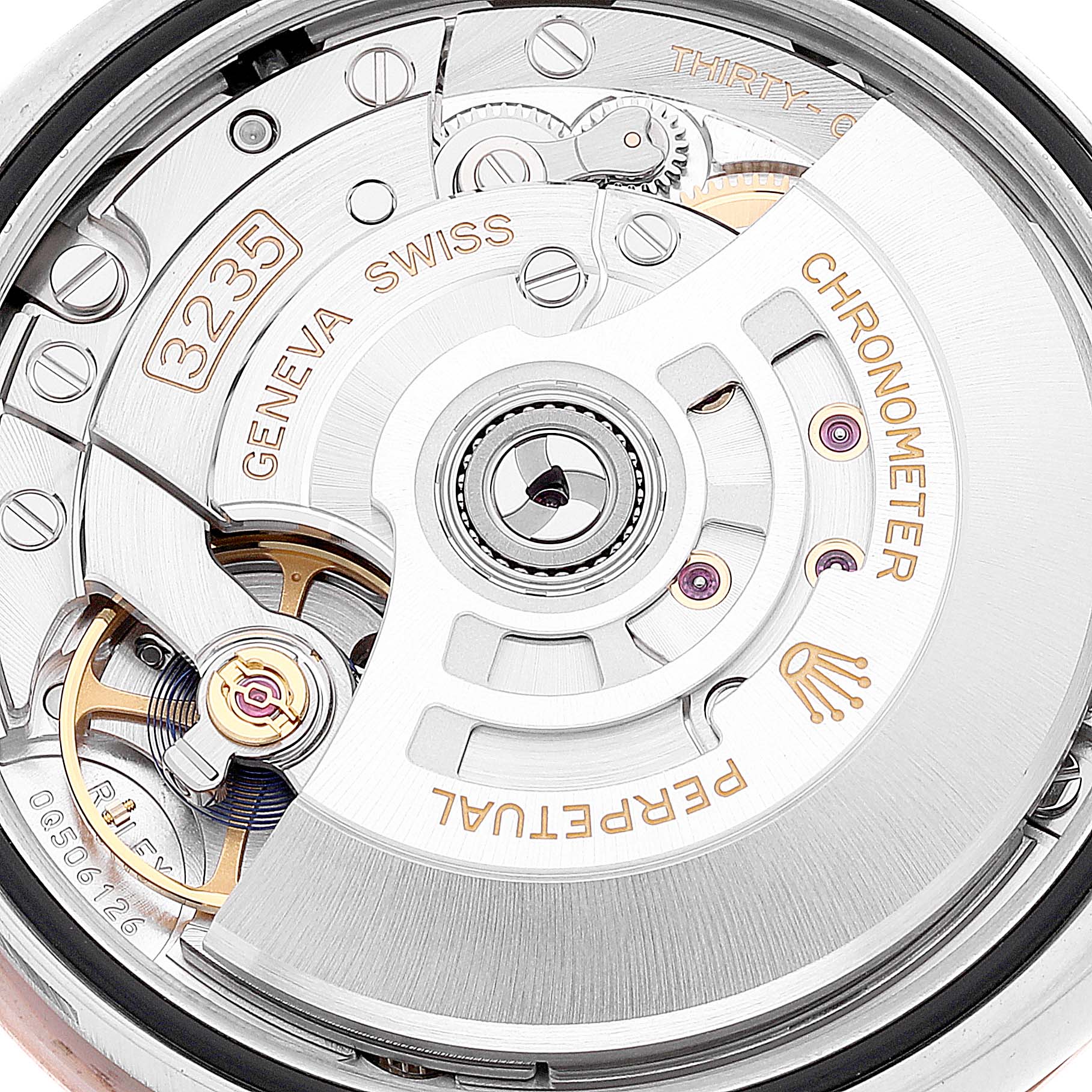 This image shows the detailed movement mechanism of a Rolex Datejust 126201 Men's Steel and Gold (two tone) Grey Dial 126201 Men's Steel and Gold (two tone) Grey Dial watch, highlighting components like the rotor and engravings.