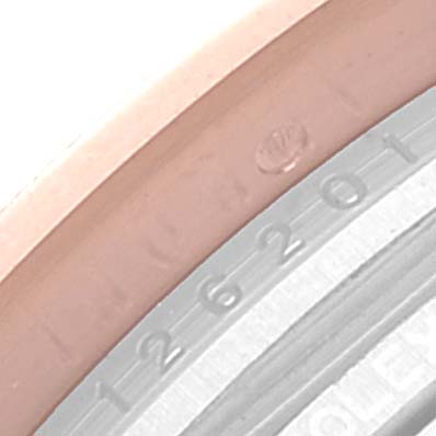 The image shows a close-up of the edge of the face and bezel of a Rolex Datejust 126201 Men's Steel and Gold (two tone) Grey Dial 126201 Men's Steel and Gold (two tone) Grey Dial watch, featuring part of its serial number and logo engraving.