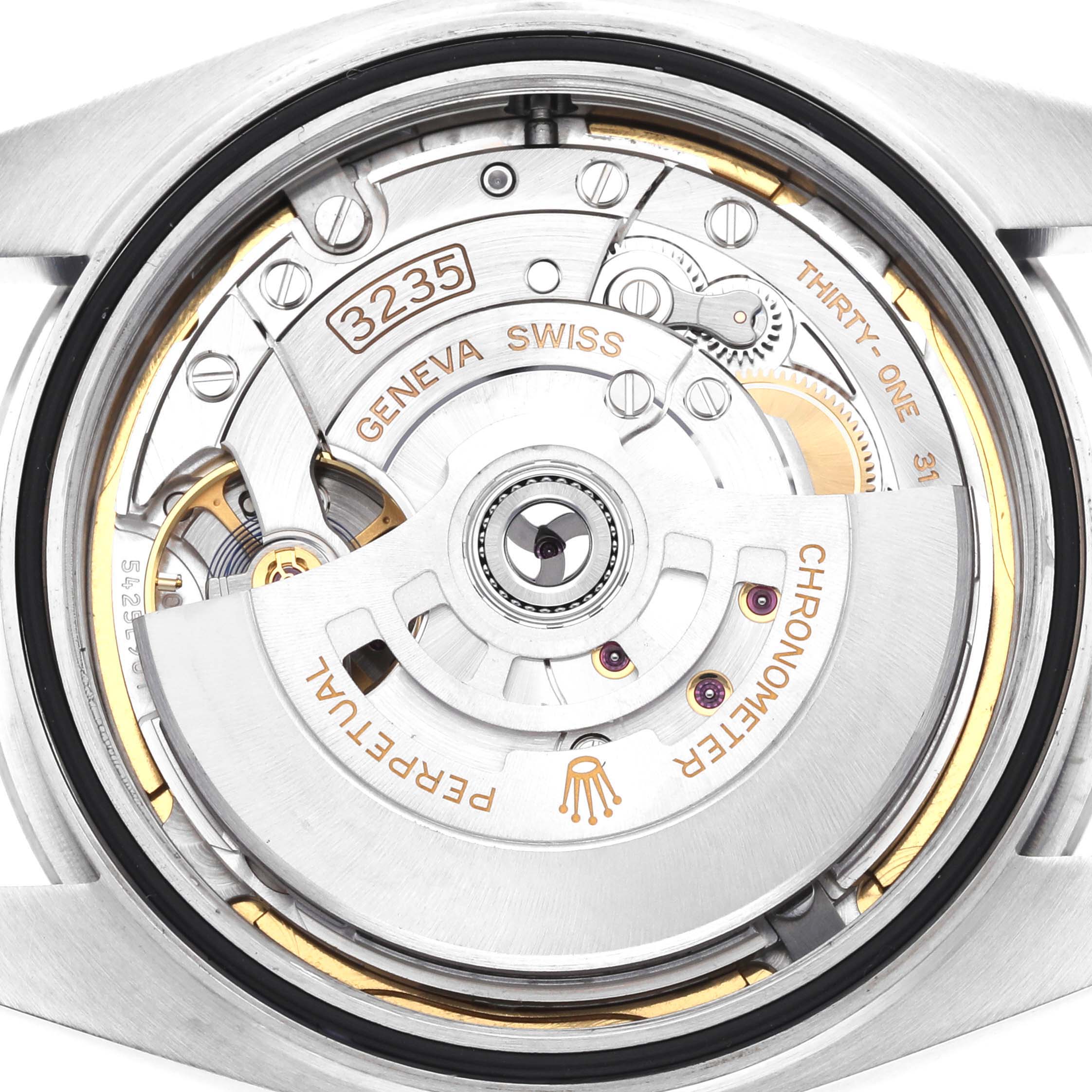 The image shows the movement of a Rolex Datejust 41 126300 Men's Stainless Steel Blue Dial 126300 Men's Stainless Steel Blue Dial watch, viewed from the back, highlighting the rotor and internal mechanisms.