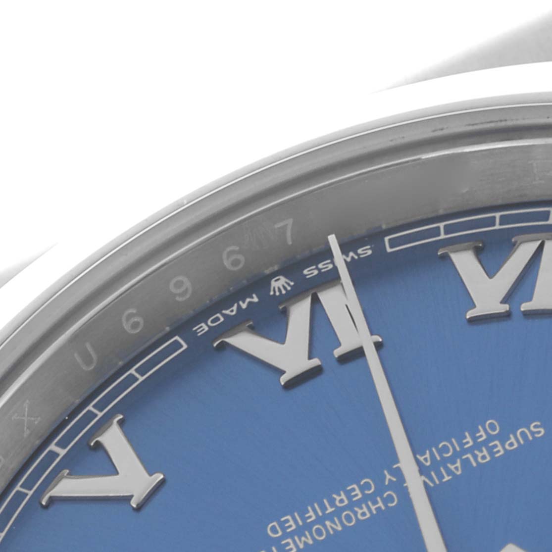 The image shows a close-up of the Rolex Datejust 41 126300 Men's Stainless Steel Blue Dial 126300 Men's Stainless Steel Blue Dial's dial, highlighting Roman numerals and part of the bezel.