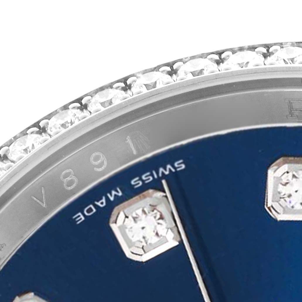 The image shows a close-up of the bezel and dial of a Rolex Datejust 116244 Men's Stainless Steel Blue Dial 116244 Men's Stainless Steel Blue Dial, highlighting diamond markers and "SWISS MADE" text.