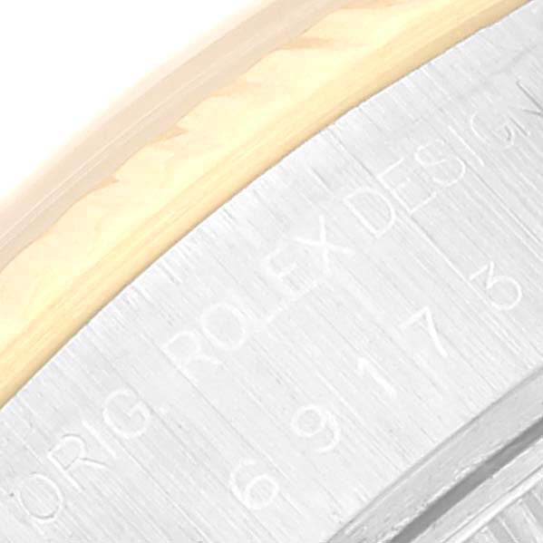 The image shows a close-up of the case side of a Rolex Datejust 69173 Women's Steel and Gold (two tone) Champagne Dial 69173 Women's Steel and Gold (two tone) Champagne Dial watch, highlighting the branding and serial numbers.