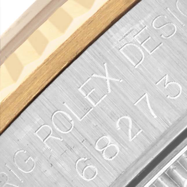 The image shows a close-up of the side engraving on the bezel of a Rolex Mid-Size 68273 Women's Steel and Gold (two tone) Champagne Dial 68273 Women's Steel and Gold (two tone) Champagne Dial model watch.