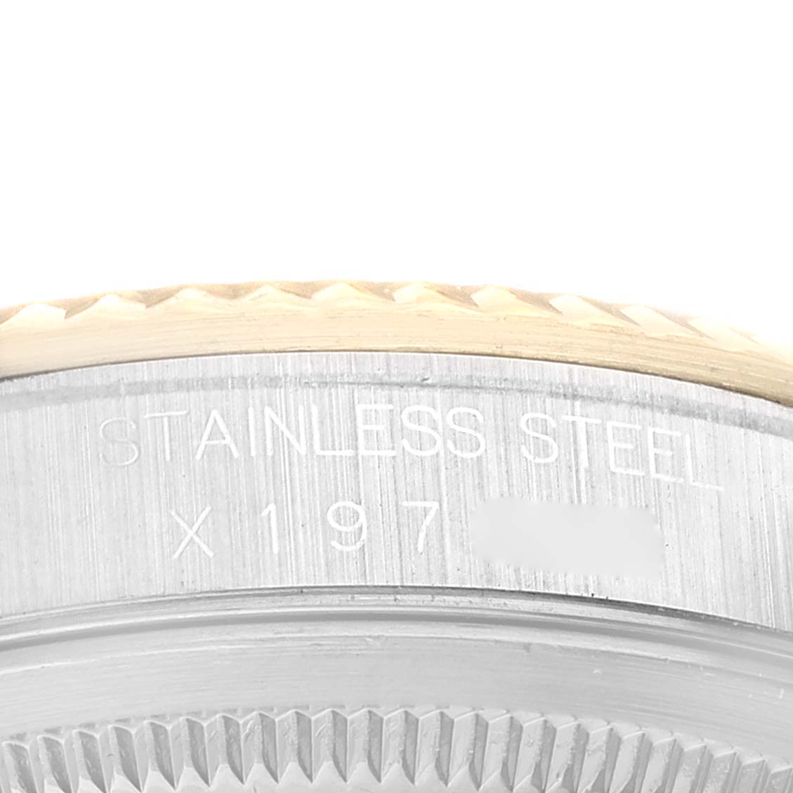 The image shows a close-up angle of the caseback and edge of the bezel of a Rolex Datejust 16233 Men's Steel and Gold (two tone) Champagne Dial 16233 Men's Steel and Gold (two tone) Champagne Dial watch, highlighting the "Stainless Steel" engraving.