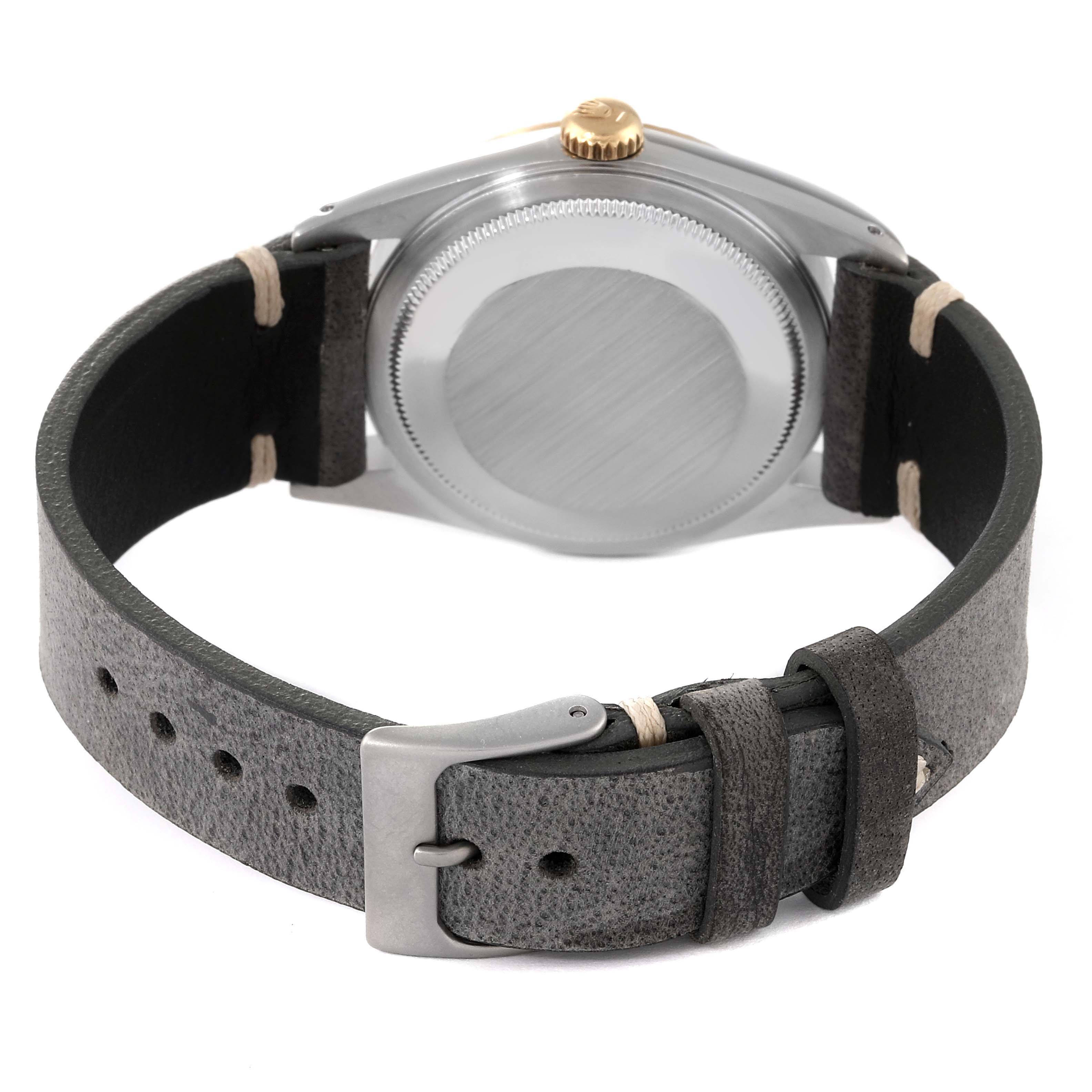 The image shows the backside and strap of a Rolex Datejust 16233 Men's Steel and Gold (two tone) Champagne Dial 16233 Men's Steel and Gold (two tone) Champagne Dial watch, featuring a leather band and metal buckle.