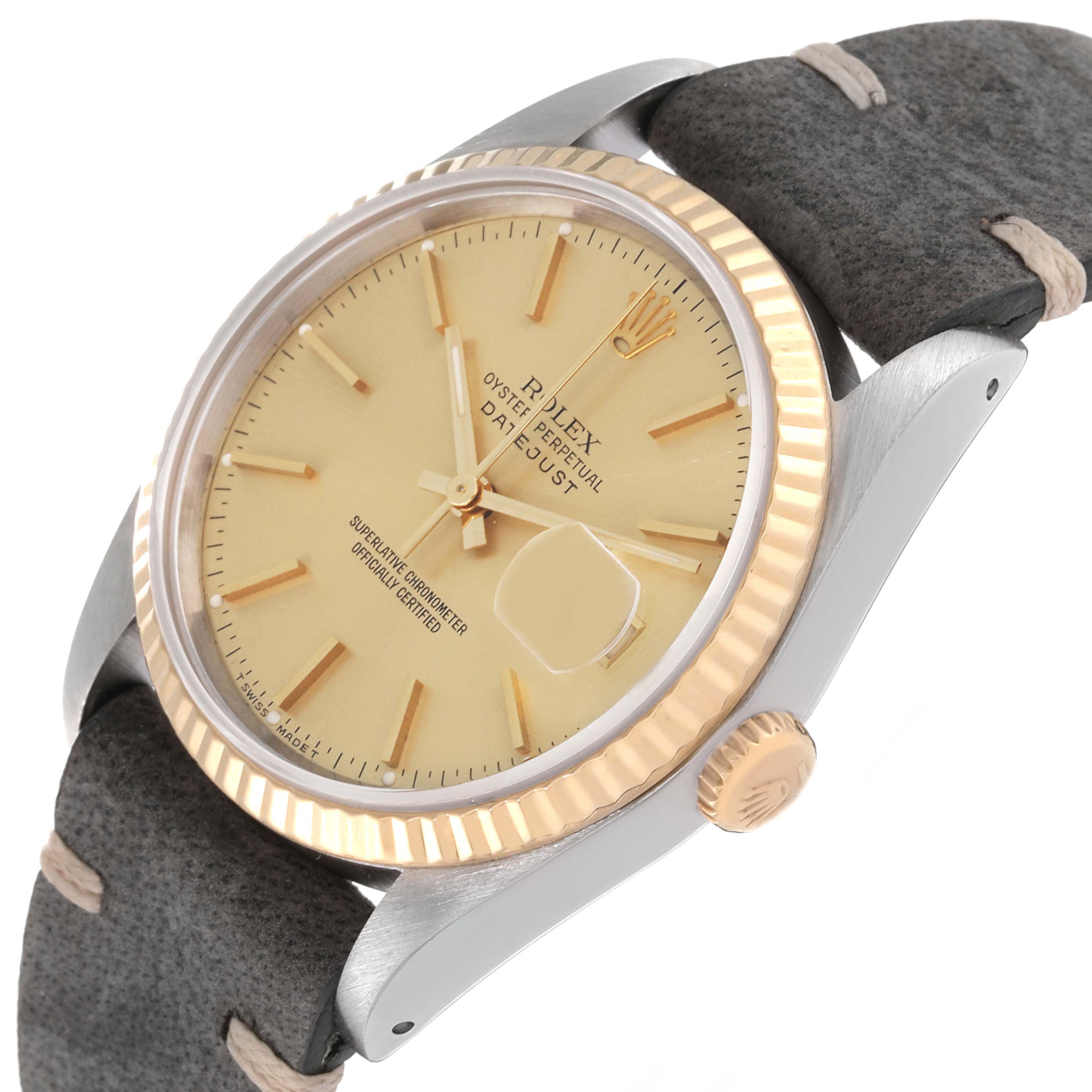 This image shows a Rolex Datejust 16233 Men's Steel and Gold (two tone) Champagne Dial 16233 Men's Steel and Gold (two tone) Champagne Dial watch at an angle highlighting its champagne dial, fluted bezel, and grey leather strap.