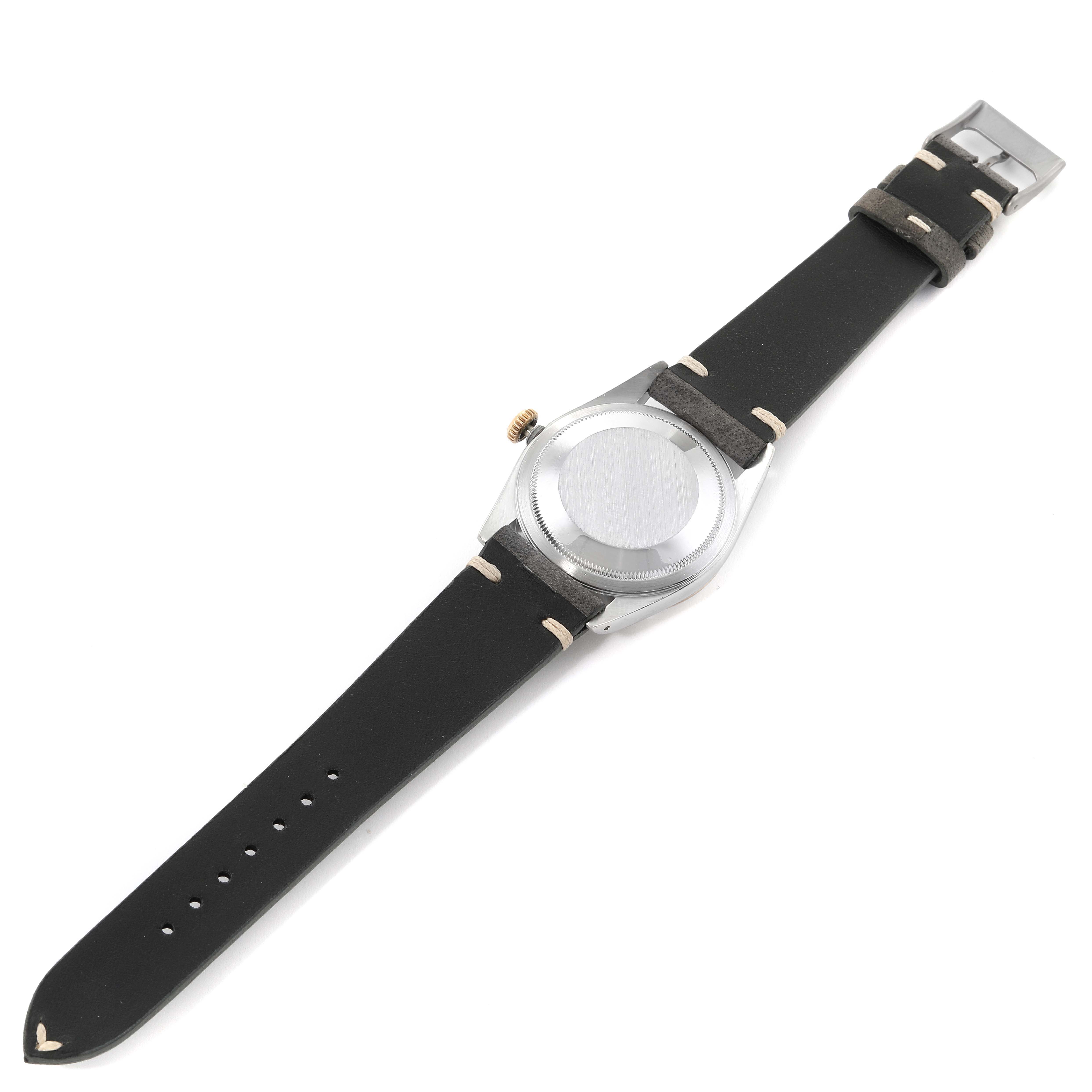 The image shows the back of a Rolex Datejust 16233 Men's Steel and Gold (two tone) Champagne Dial 16233 Men's Steel and Gold (two tone) Champagne Dial model watch with a leather strap, buckle, and case back clearly visible.