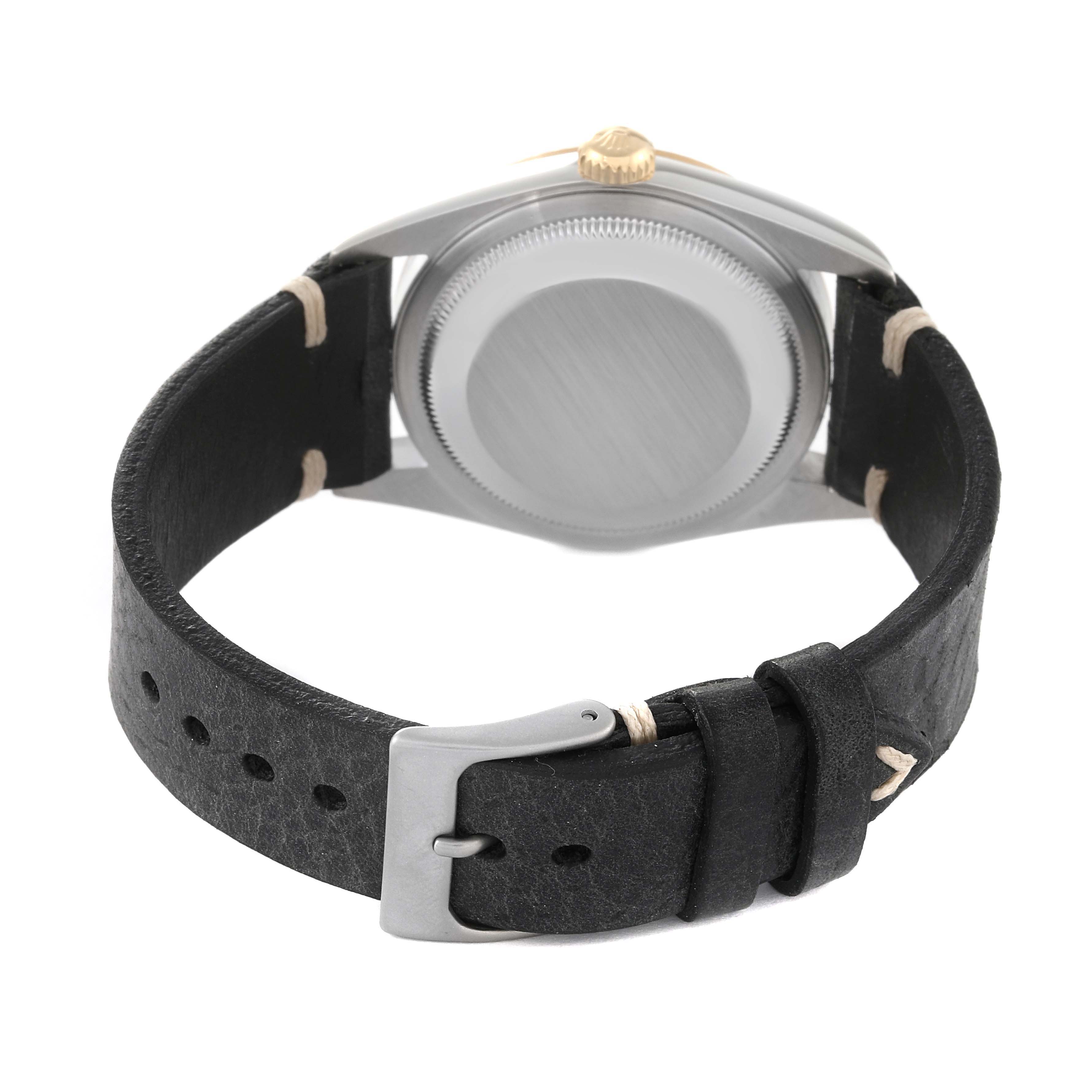 This image shows the back view of a Rolex Datejust 16233 Men's Steel and Gold (two tone) Champagne Dial 16233 Men's Steel and Gold (two tone) Champagne Dial watch, focusing on the case back and leather strap with a buckle.